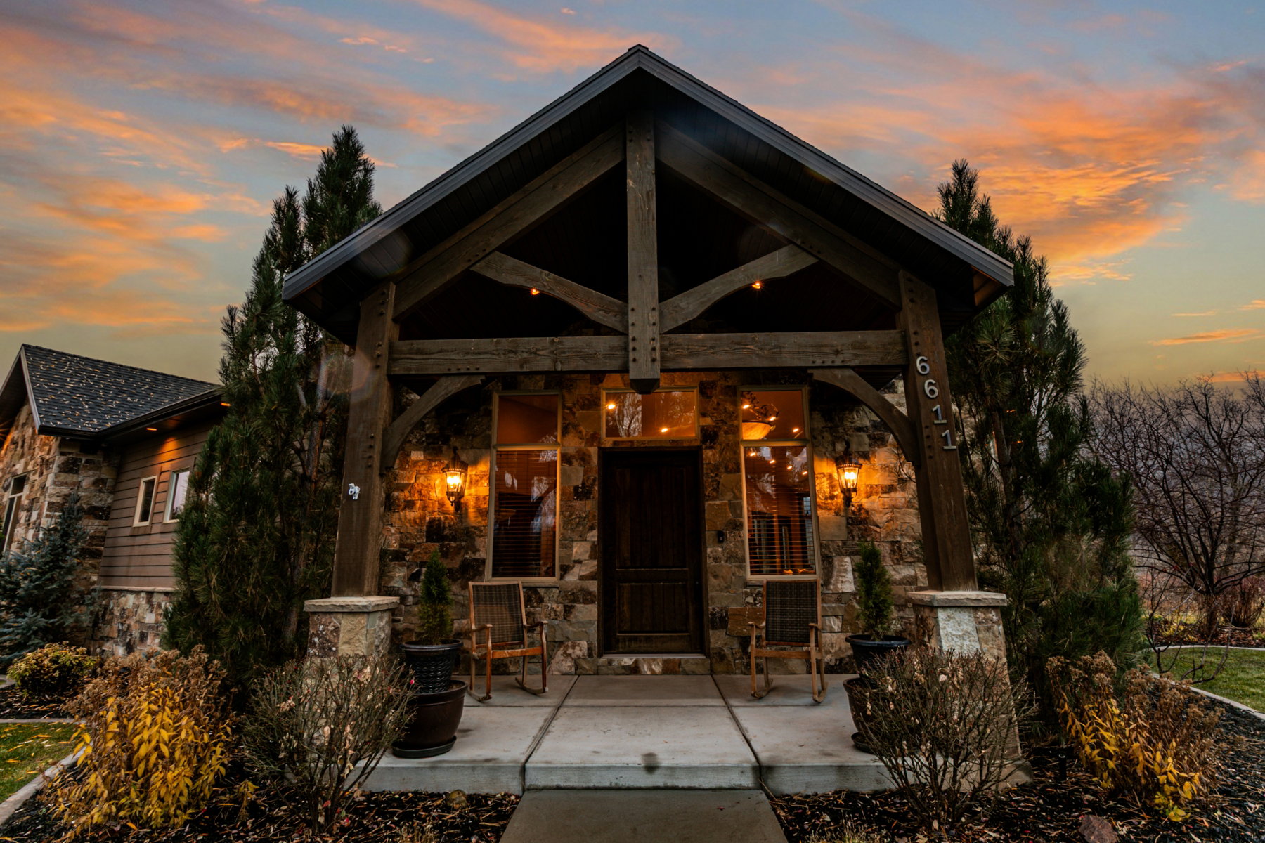 Stone and wood-clad exterior with exposed timber framing and a covered entry
