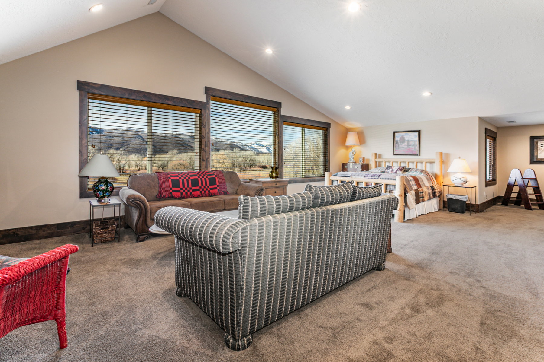 Spacious room with vaulted ceilings and recessed lighting