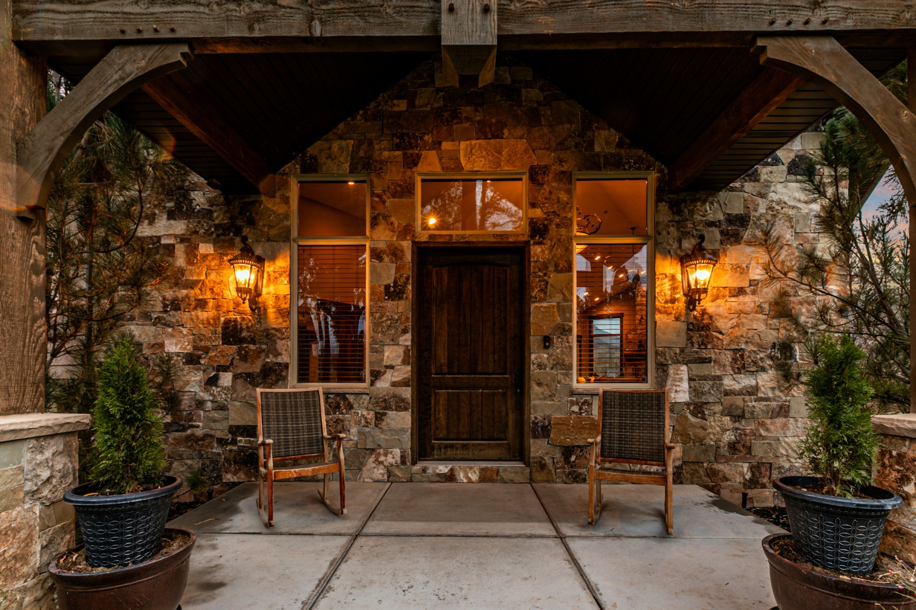 Stone veneer facade with a wood-paneled entry door