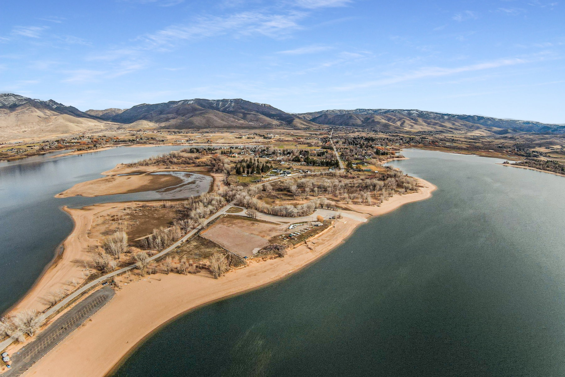 Expansive aerial perspective showcasing a significant body of water bordered by sandy shorelines