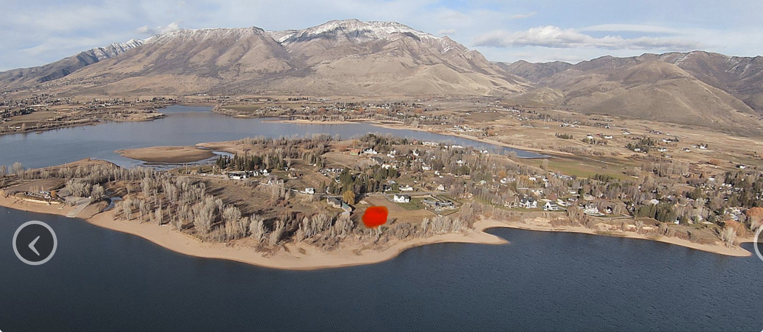 Waterfront property featuring direct shoreline access and established surrounding trees