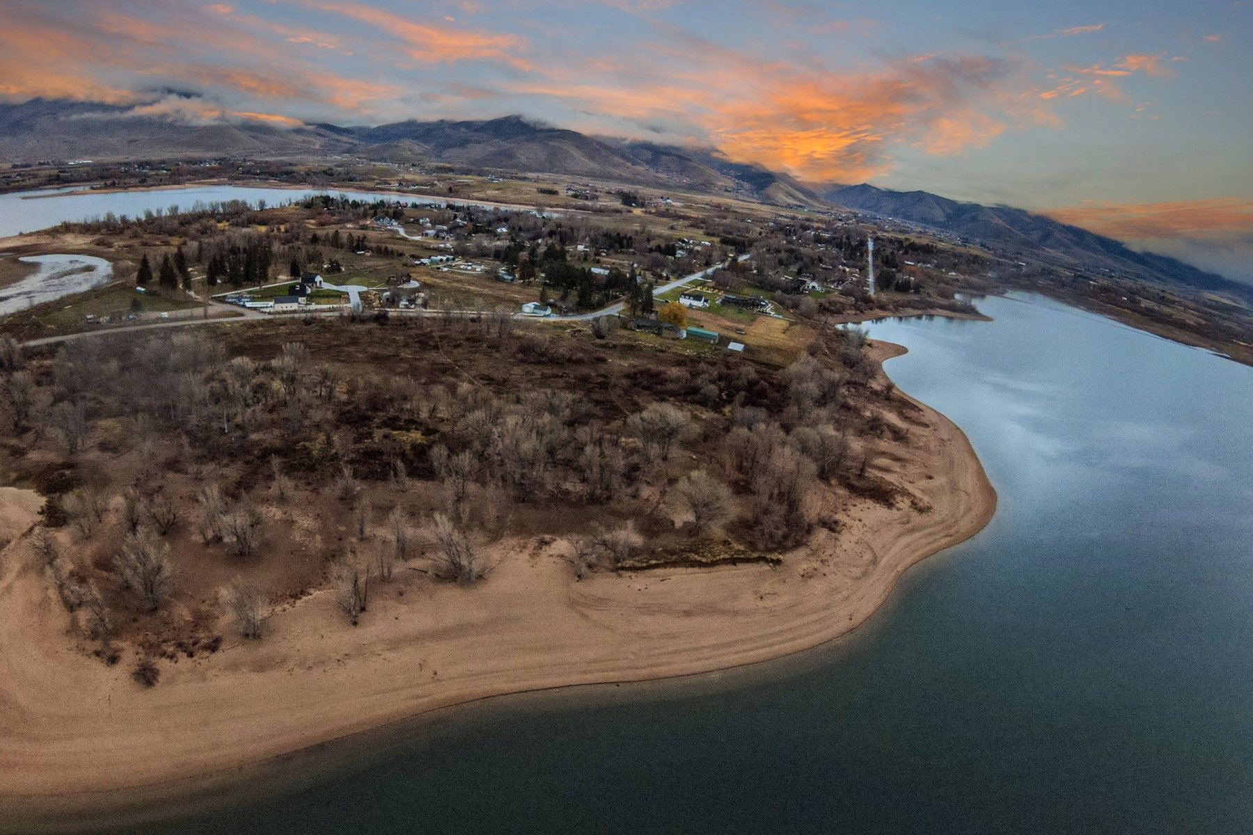 Expansive waterfront property featuring a sandy shoreline and direct water access