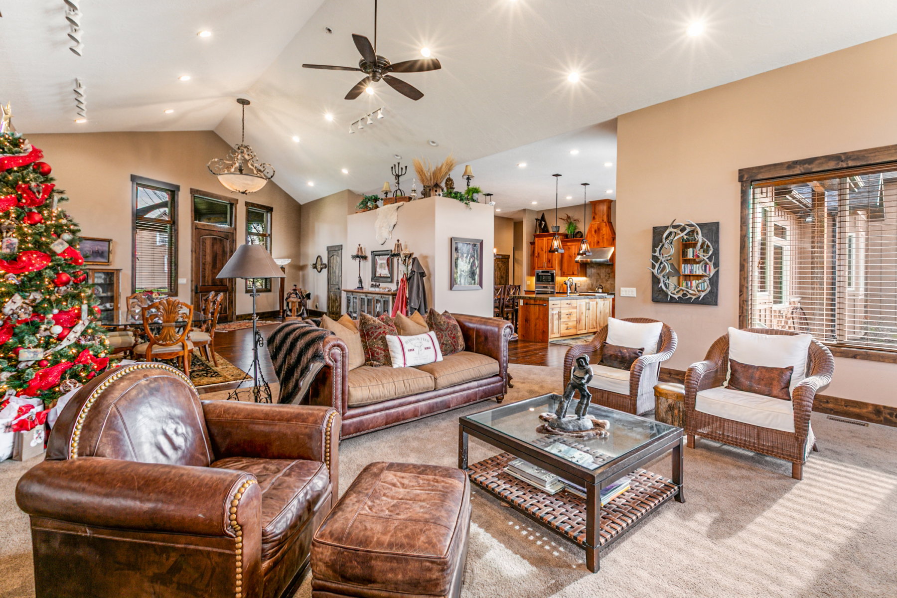 Spacious living area featuring vaulted ceilings, recessed lighting, and a ceiling fan