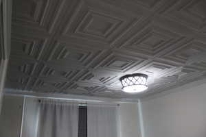 First Bedroom. Coffered ceiling with a geometric pattern and a decorative flush-mount light fixture.  first bedroom