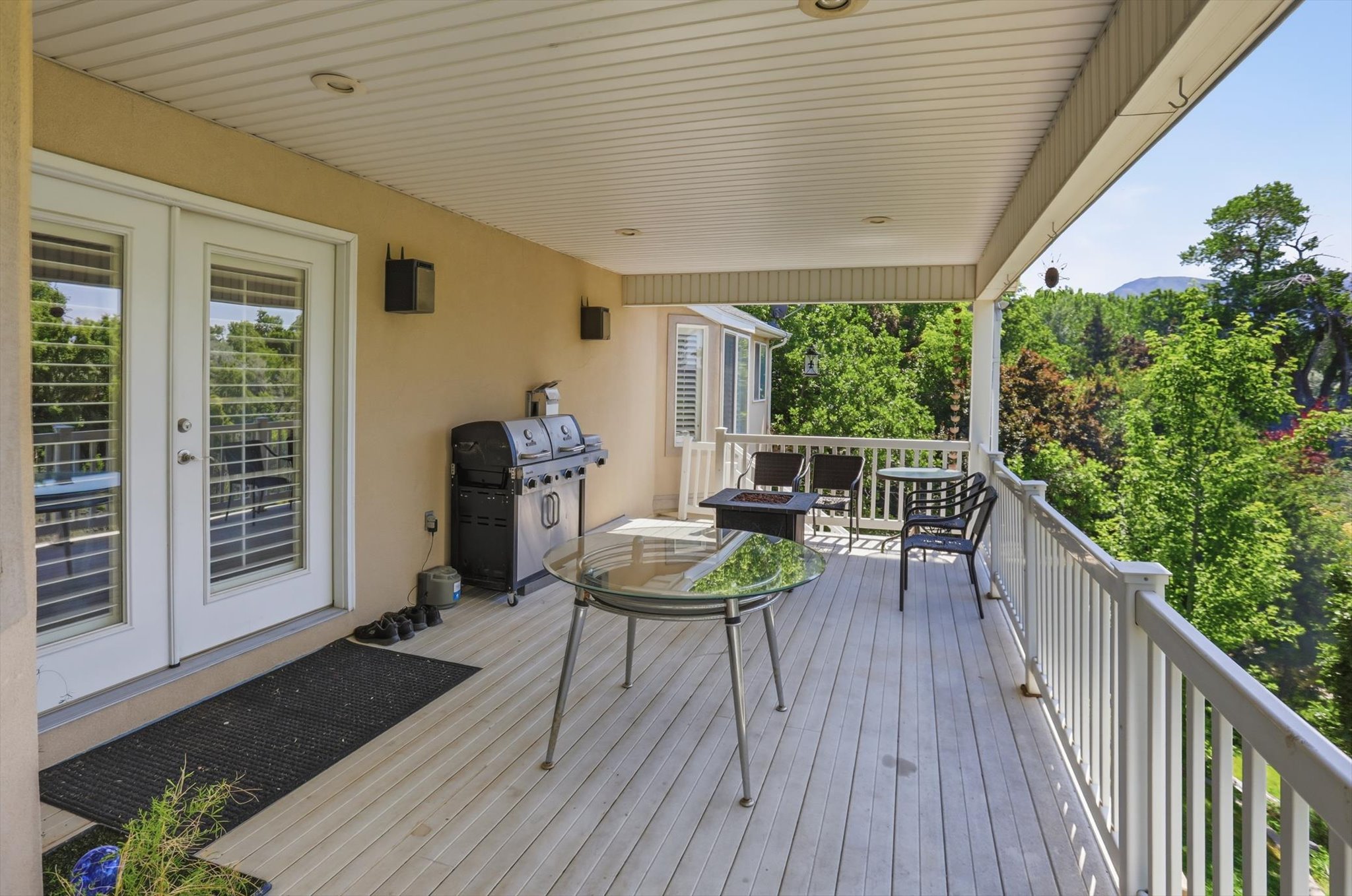 Covered outdoor deck with light wood-finish flooring