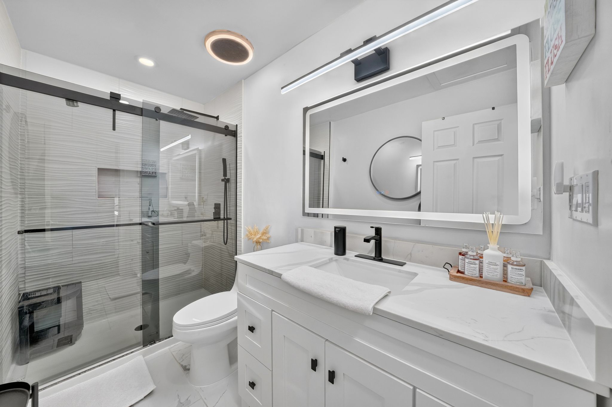 Bathroom featuring a modern vanity with a white countertop and integrated sink