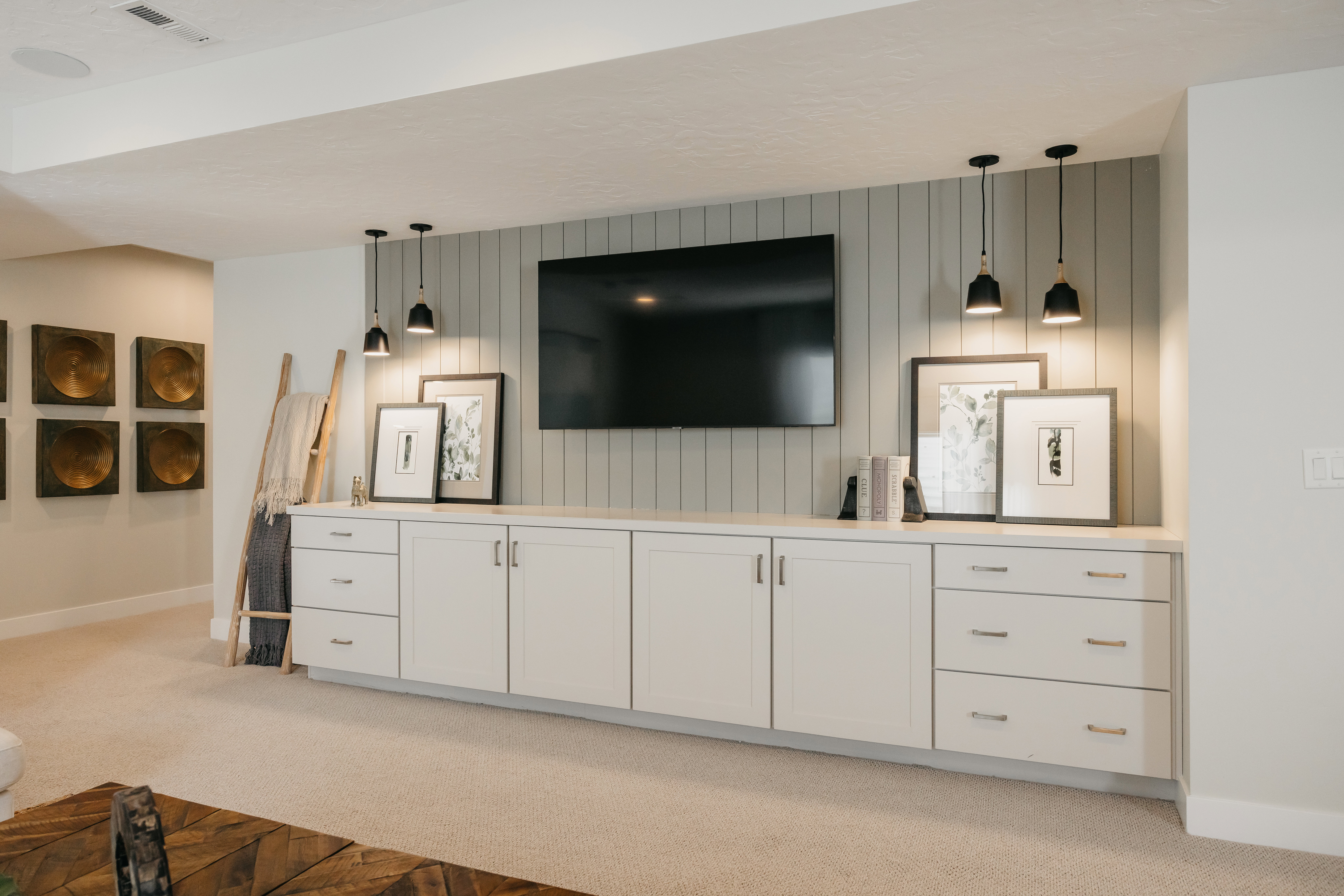Built-in media console with recessed cabinetry, drawer storage, and a light-toned countertop