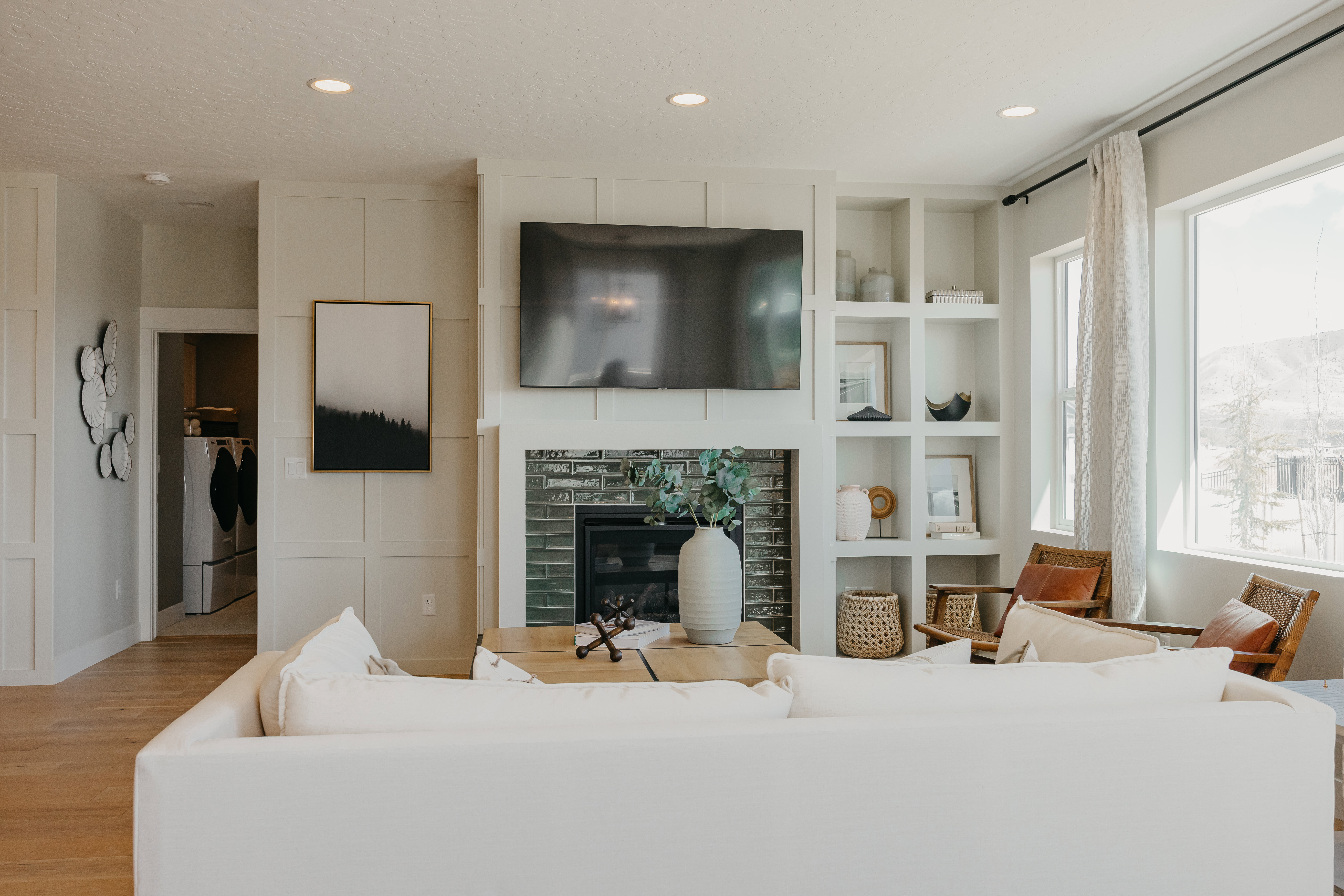 Living area featuring a fireplace with dark tile surround, built-in shelving, wood-finish flooring, and recessed lighting