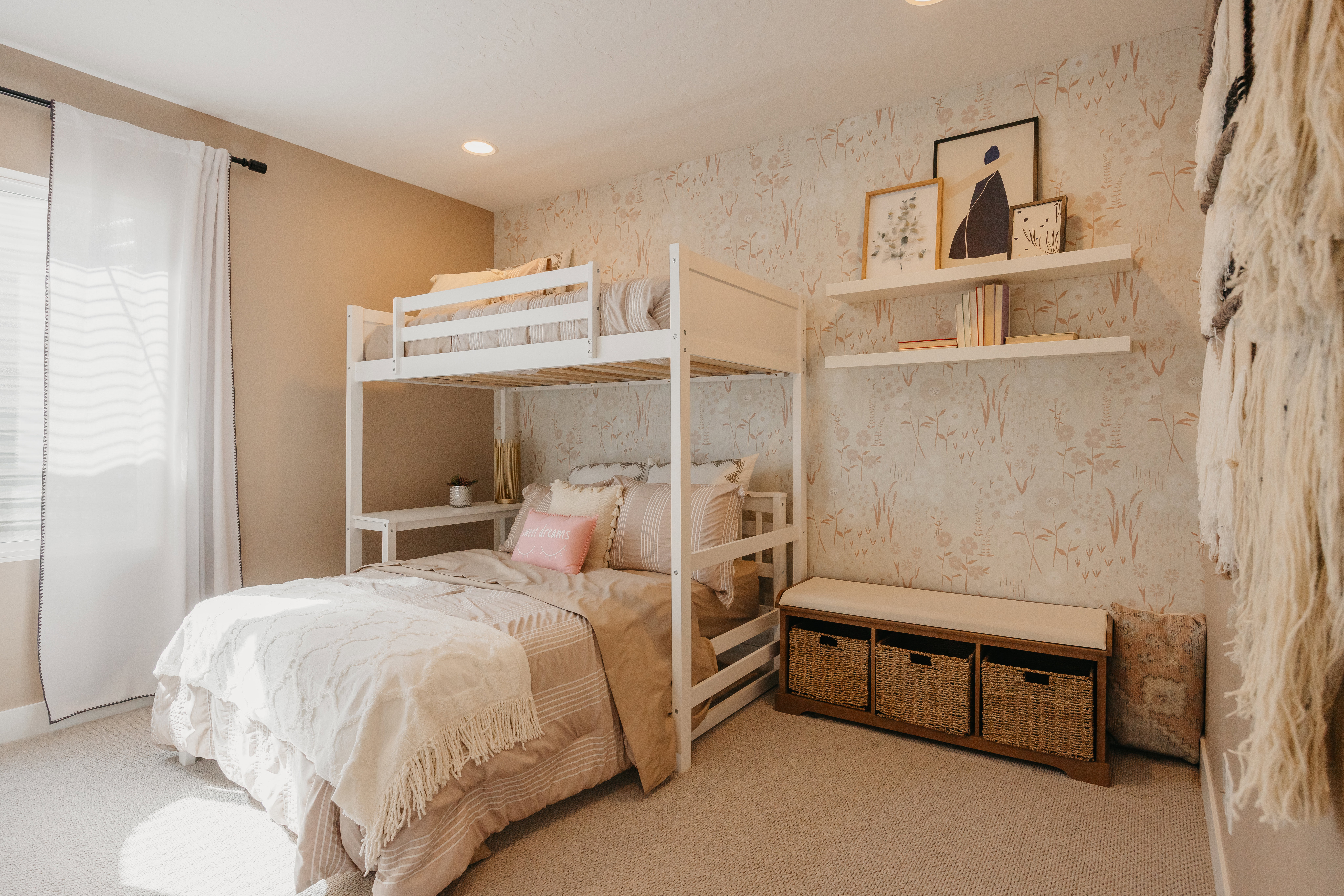 Bunk bed configuration with integrated shelving, patterned accent wall, recessed ceiling lighting, and soft carpeting