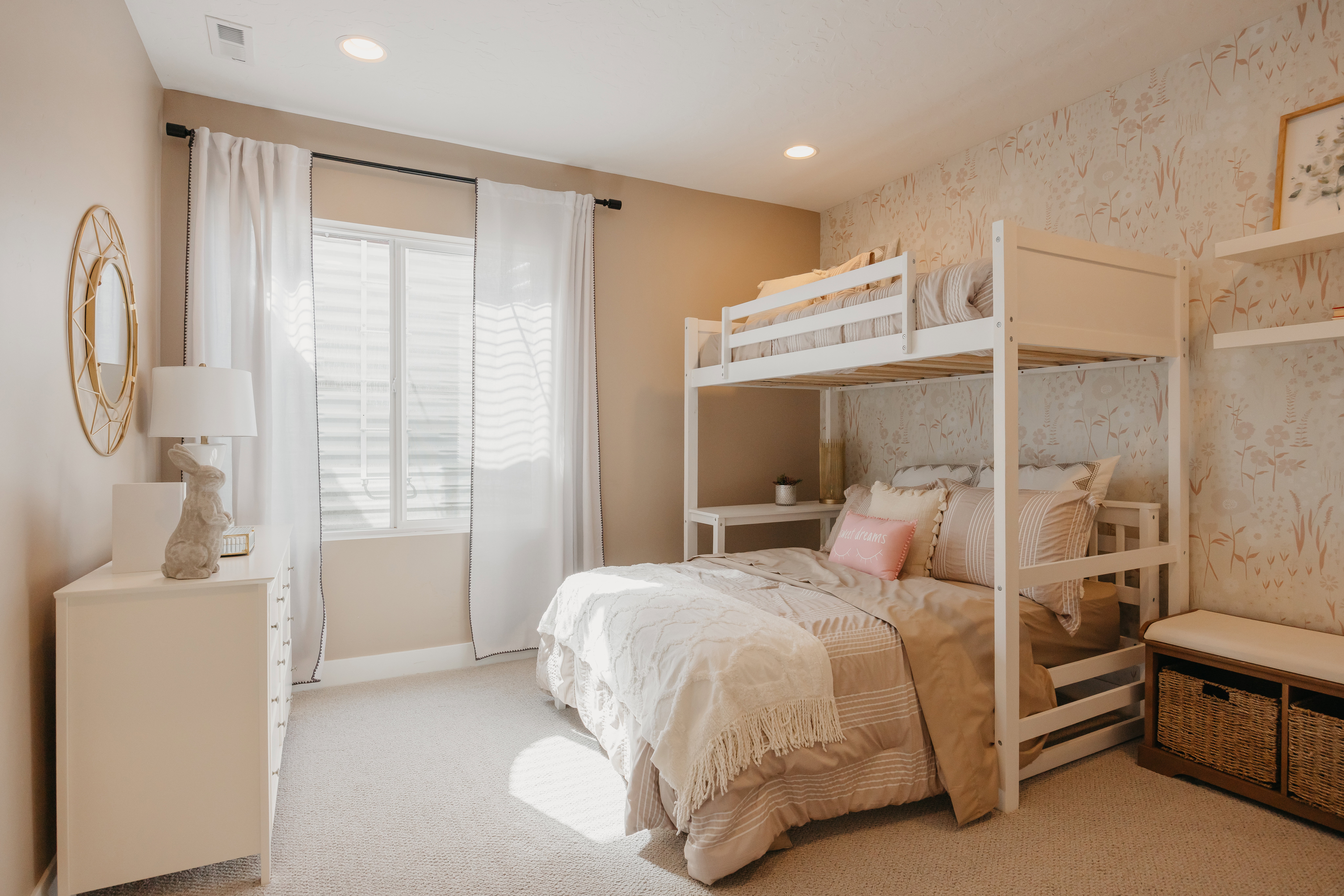 Recessed lighting illuminates this room featuring light-toned walls and plush carpeting
