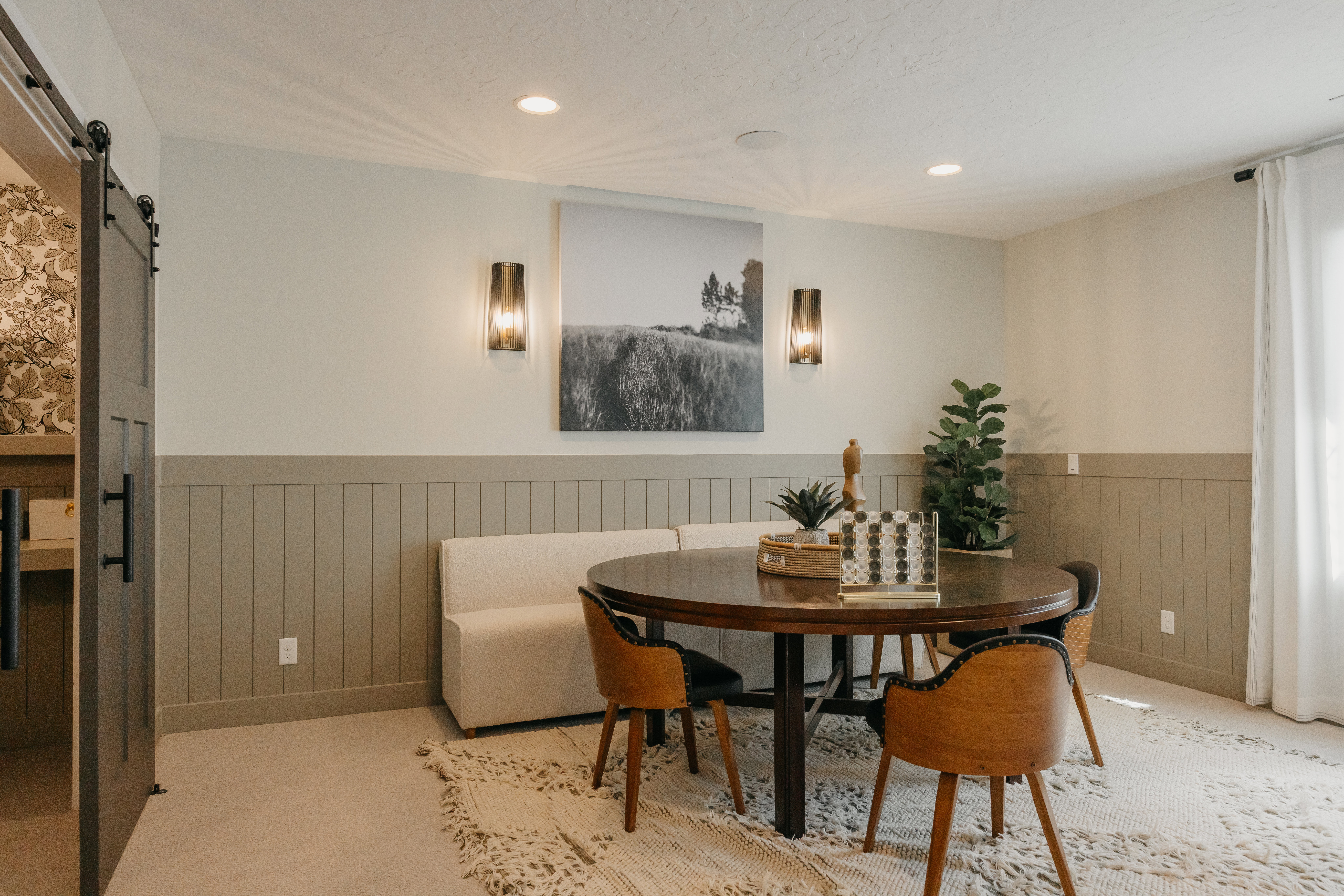 Dining area featuring board and batten wainscoting, recessed lighting, and wall sconces