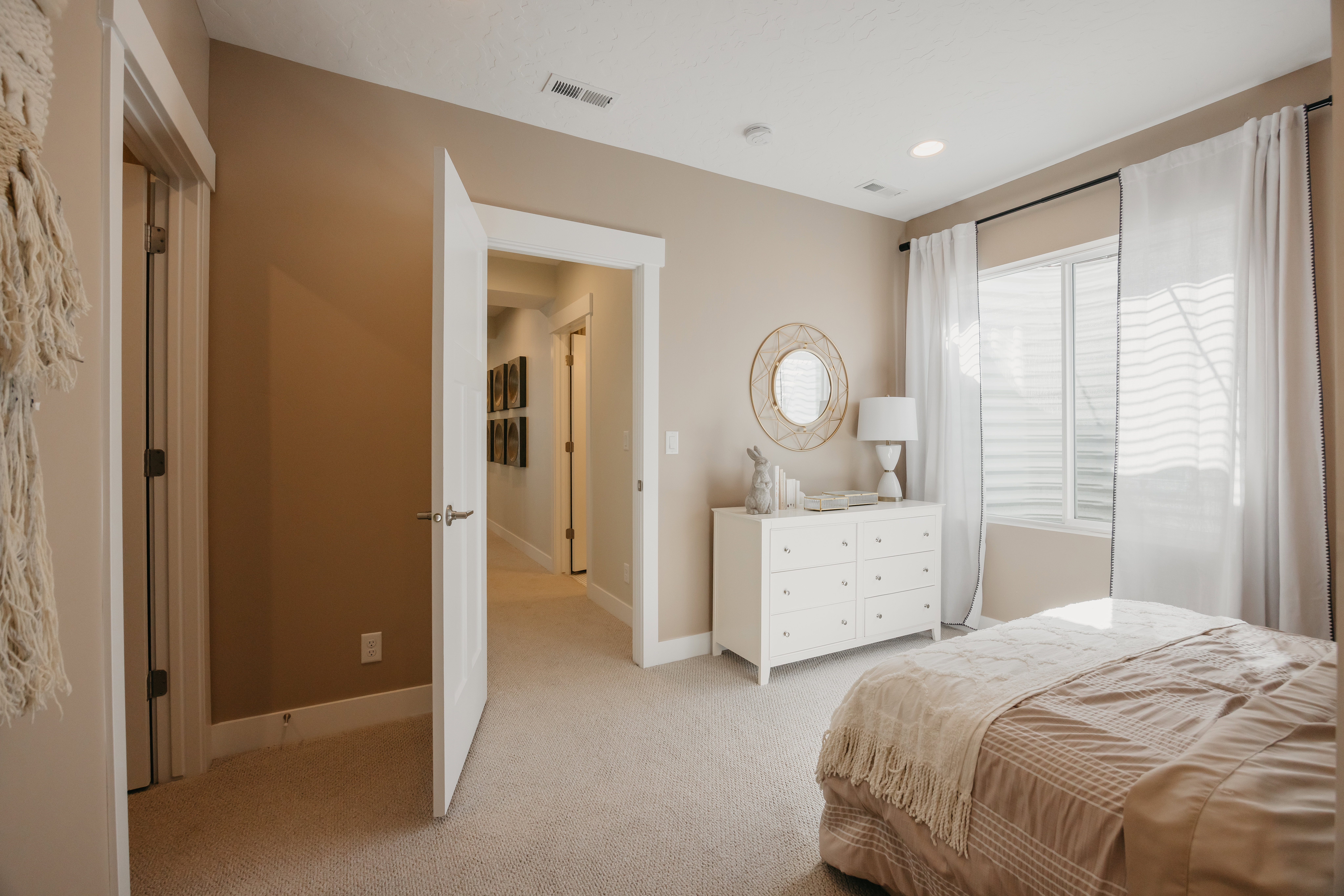 Carpeted room featuring a double-paned window with horizontal blinds, white trim, and light beige wall paint