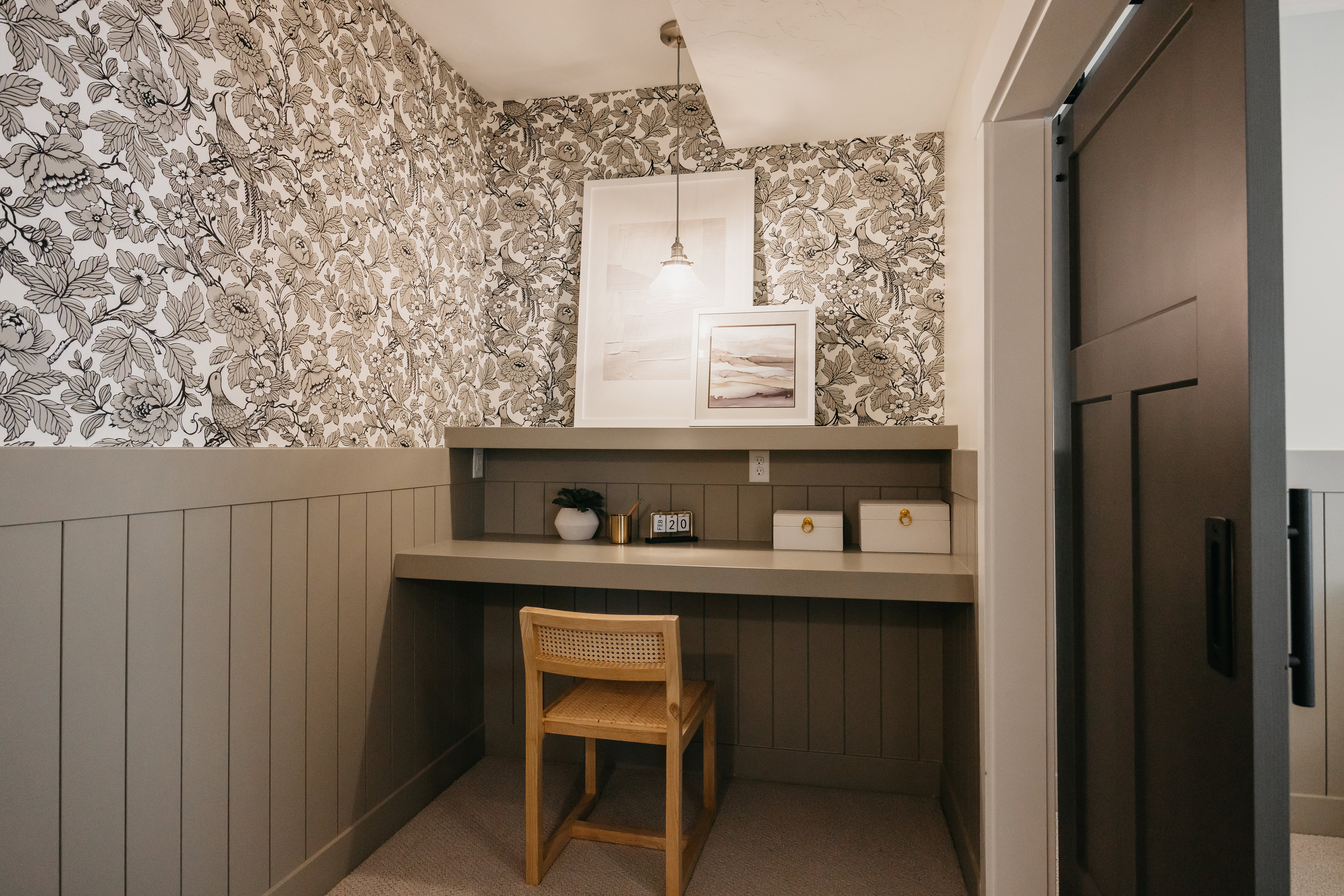 Built-in desk nook featuring a solid surface countertop and integrated shelving