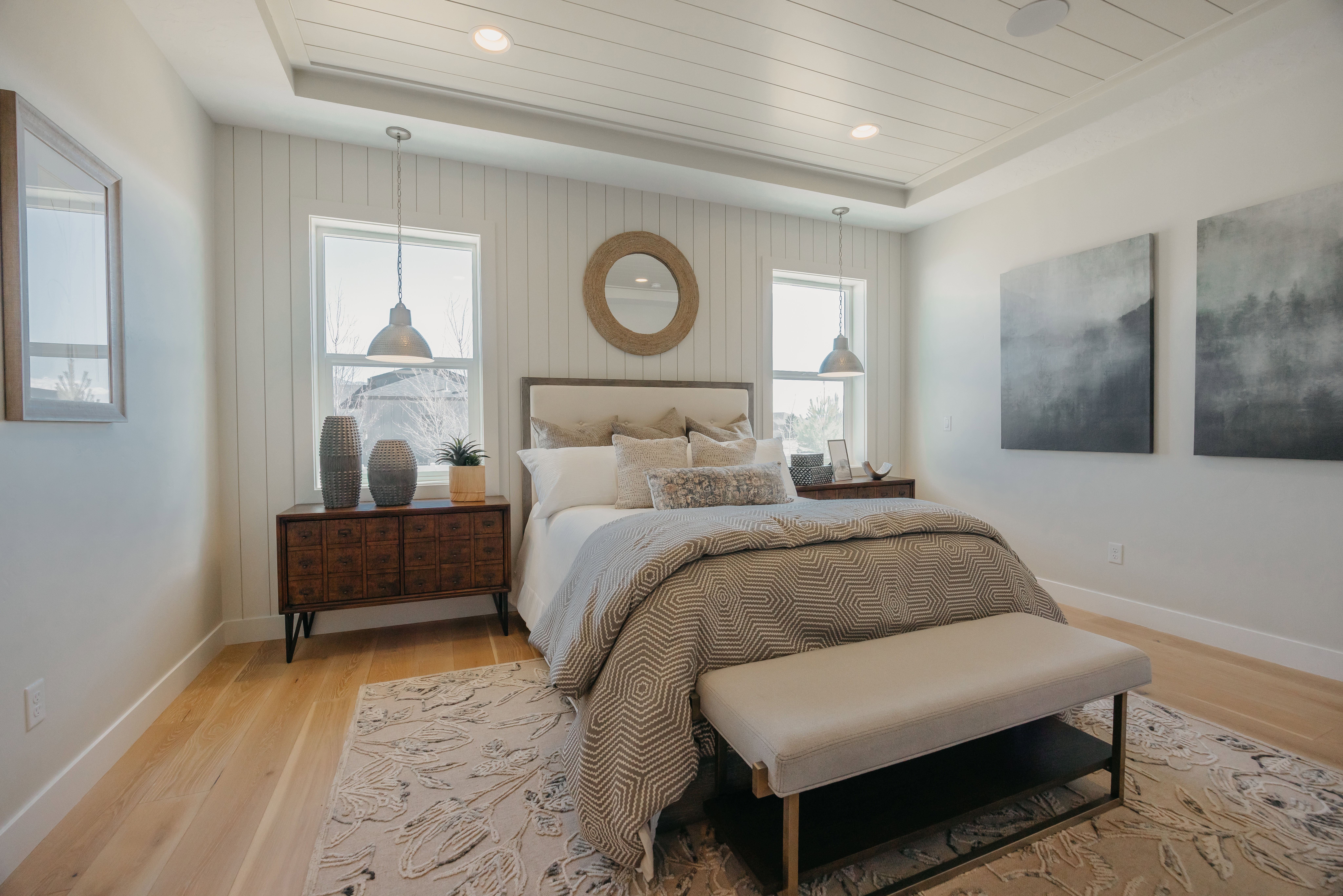 Recessed ceiling with shiplap detail, light wood-finish flooring, and white shiplap accent wall