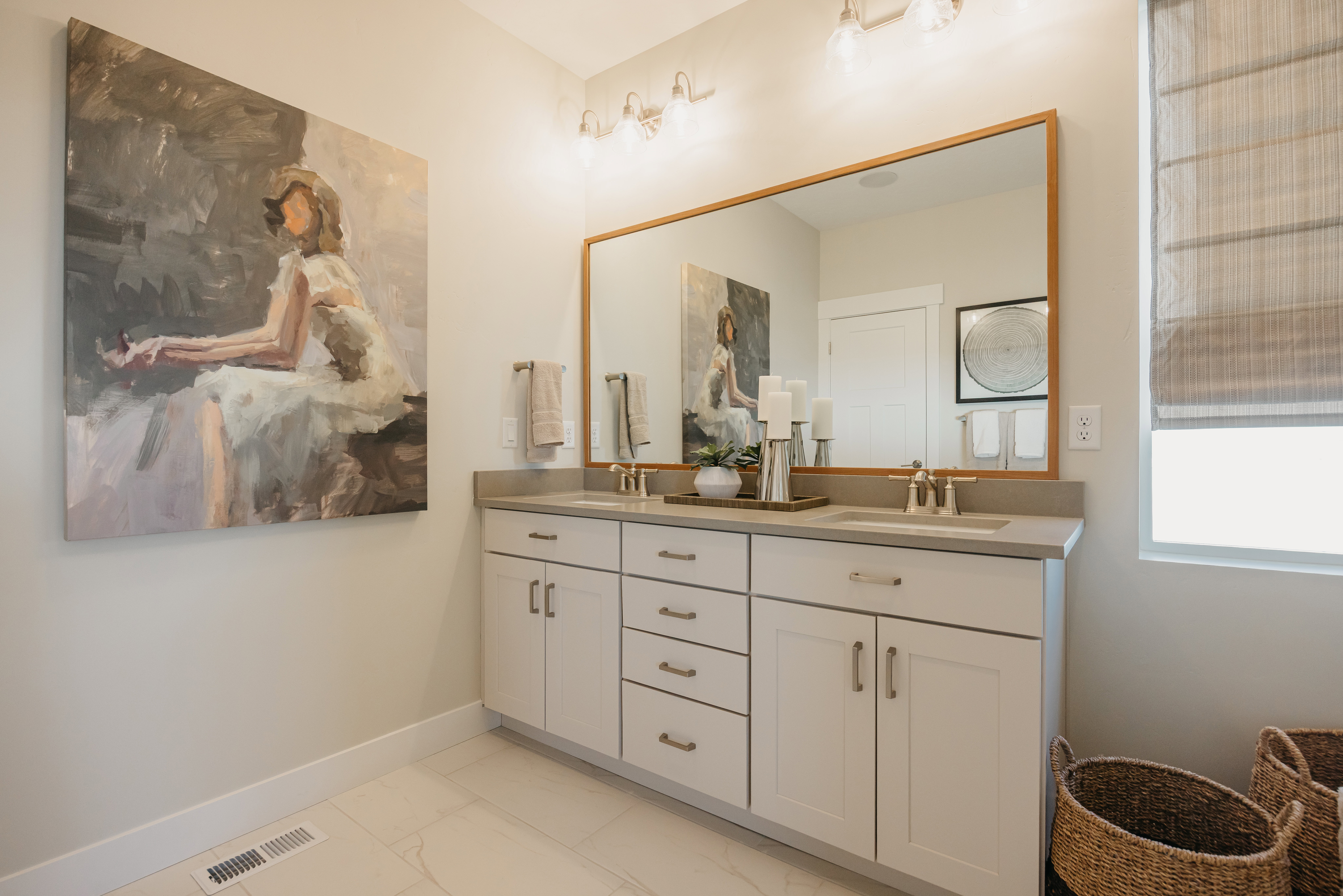 Dual vanity featuring white shaker-style cabinetry, a light-toned countertop, and undermount sinks