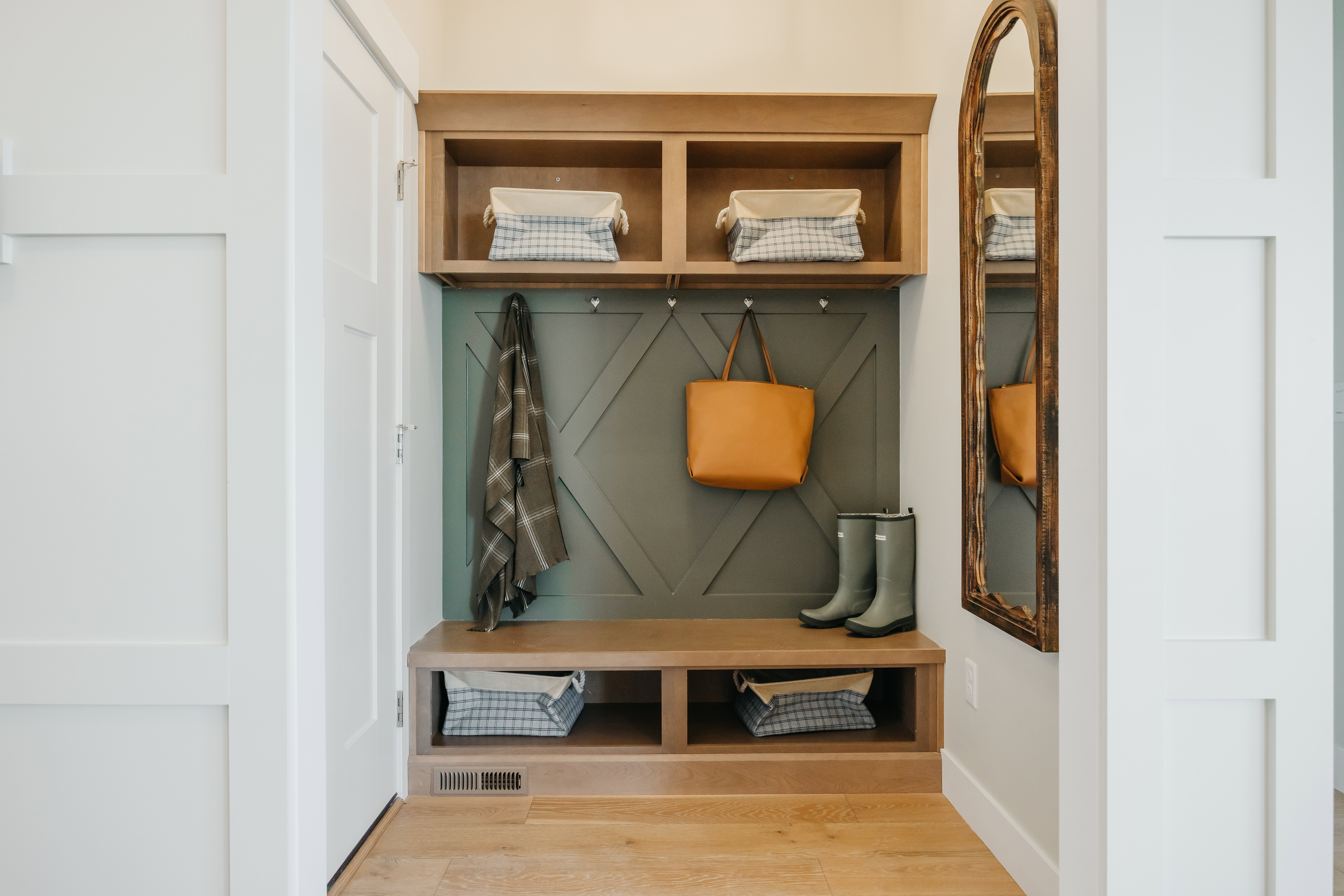 Built-in mudroom bench with cubby storage and coat hooks