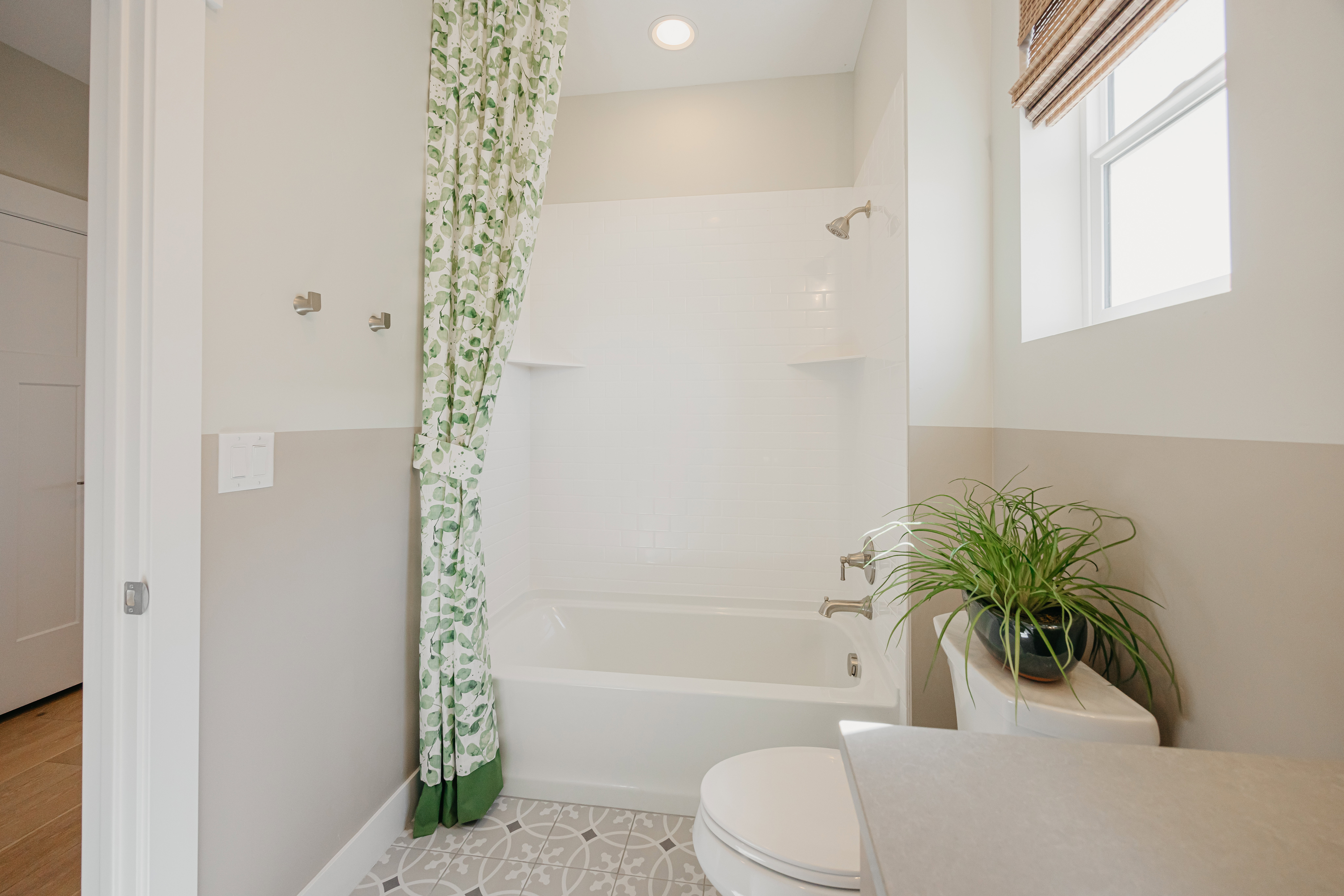 Full bathroom featuring a white tub and shower combination with chrome fixtures