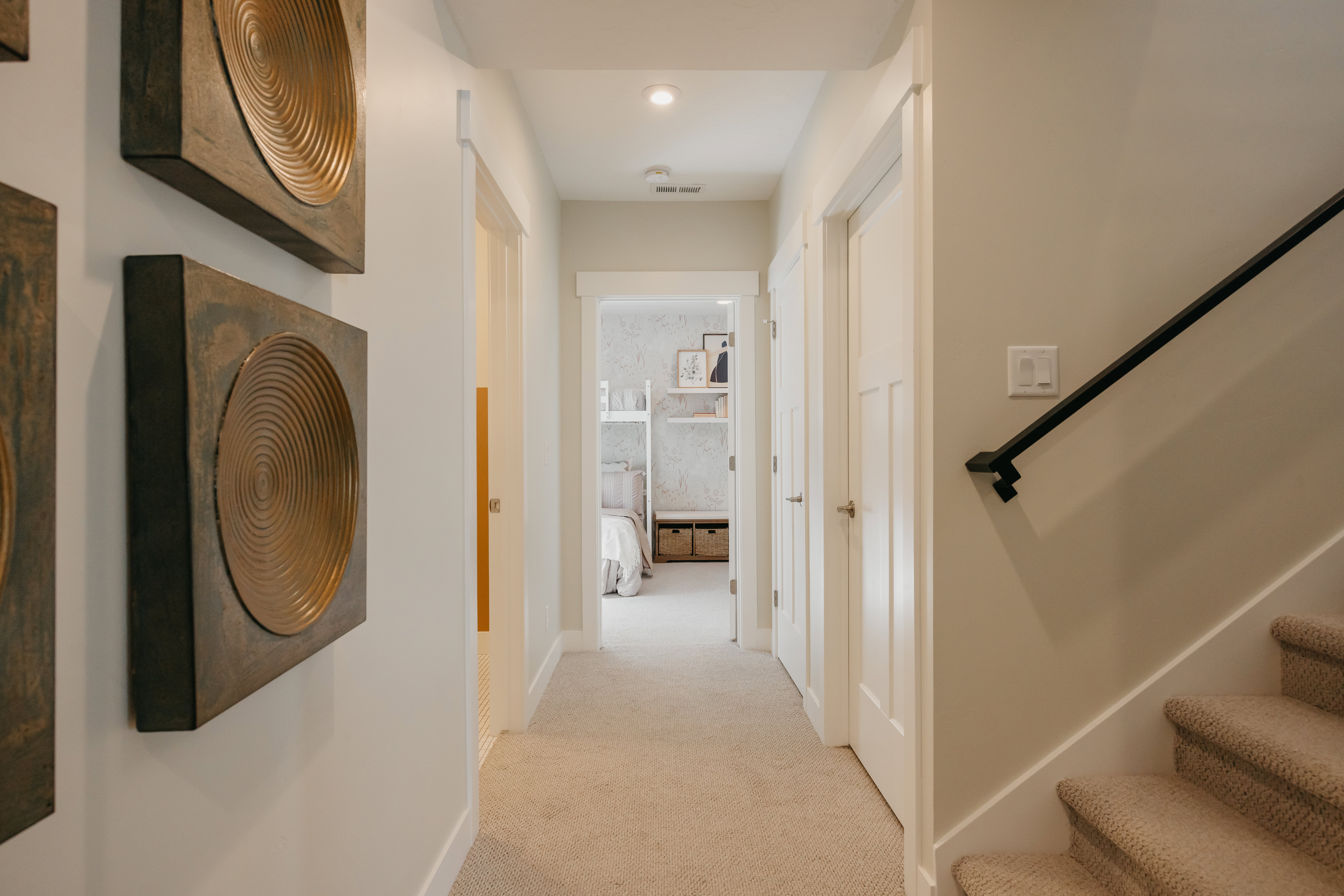 Hallway with neutral carpeting and recessed lighting