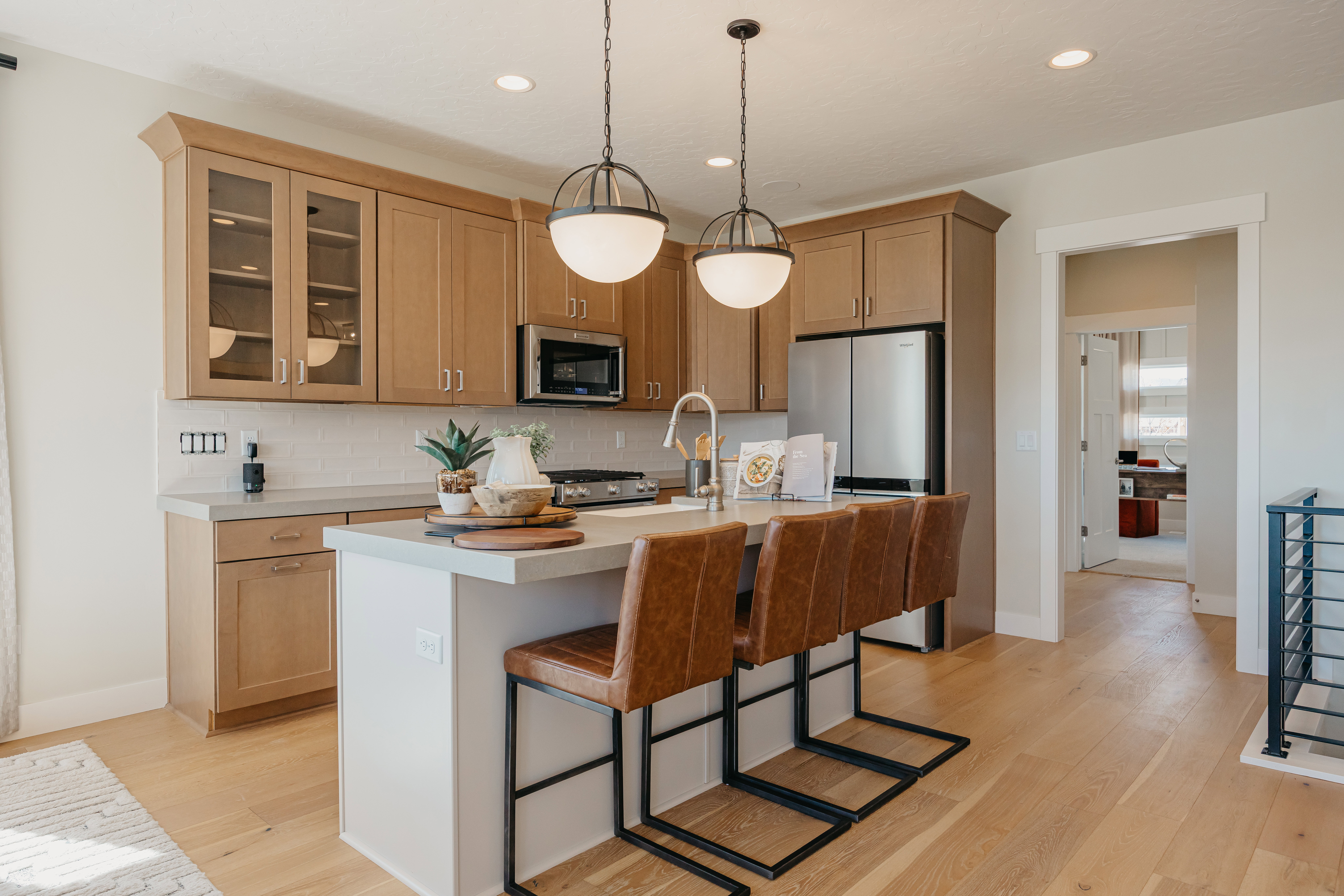 Kitchen featuring light wood-finish flooring and a central island with countertop seating