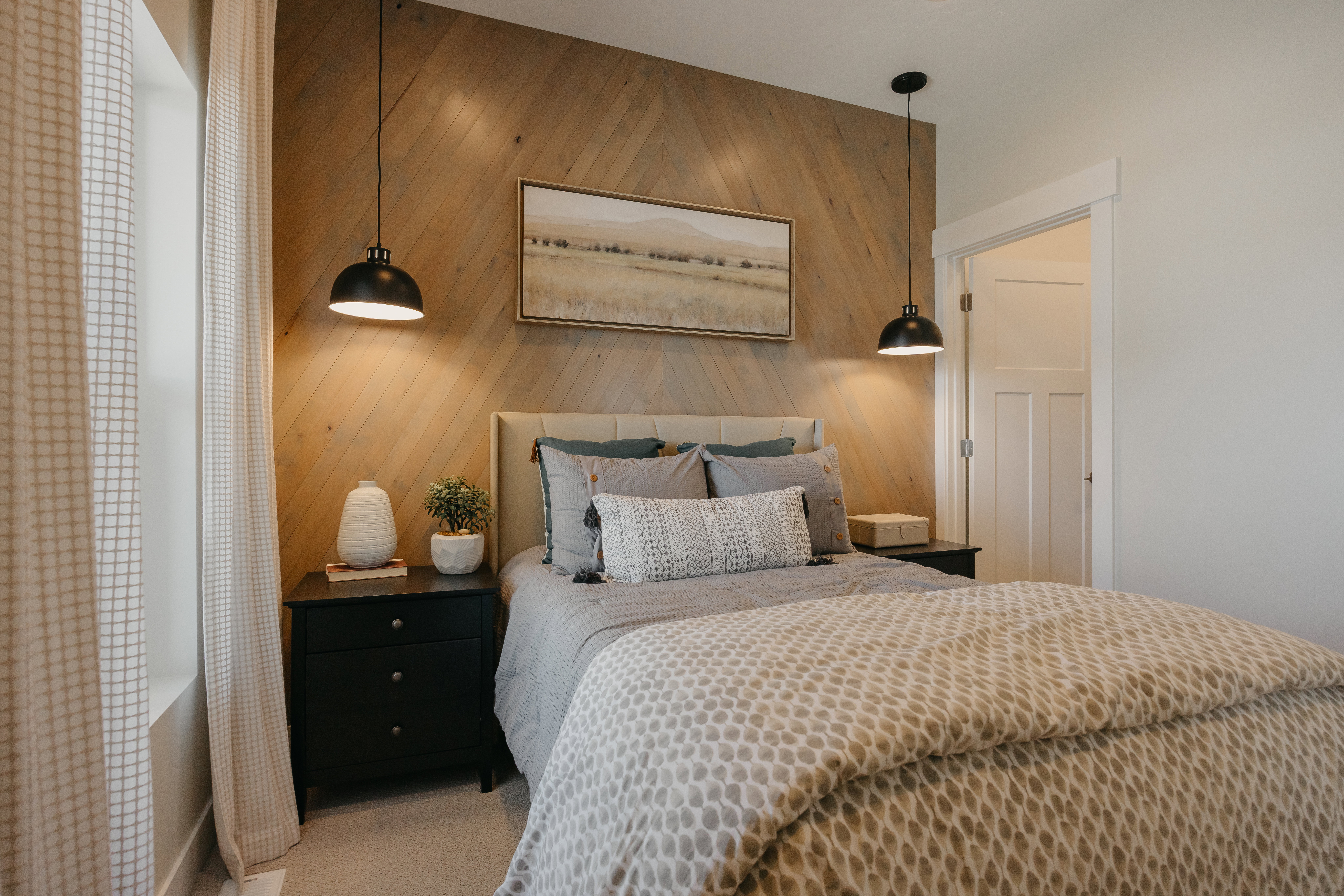 Accent wall featuring diagonal wood paneling and two suspended dome pendant lights