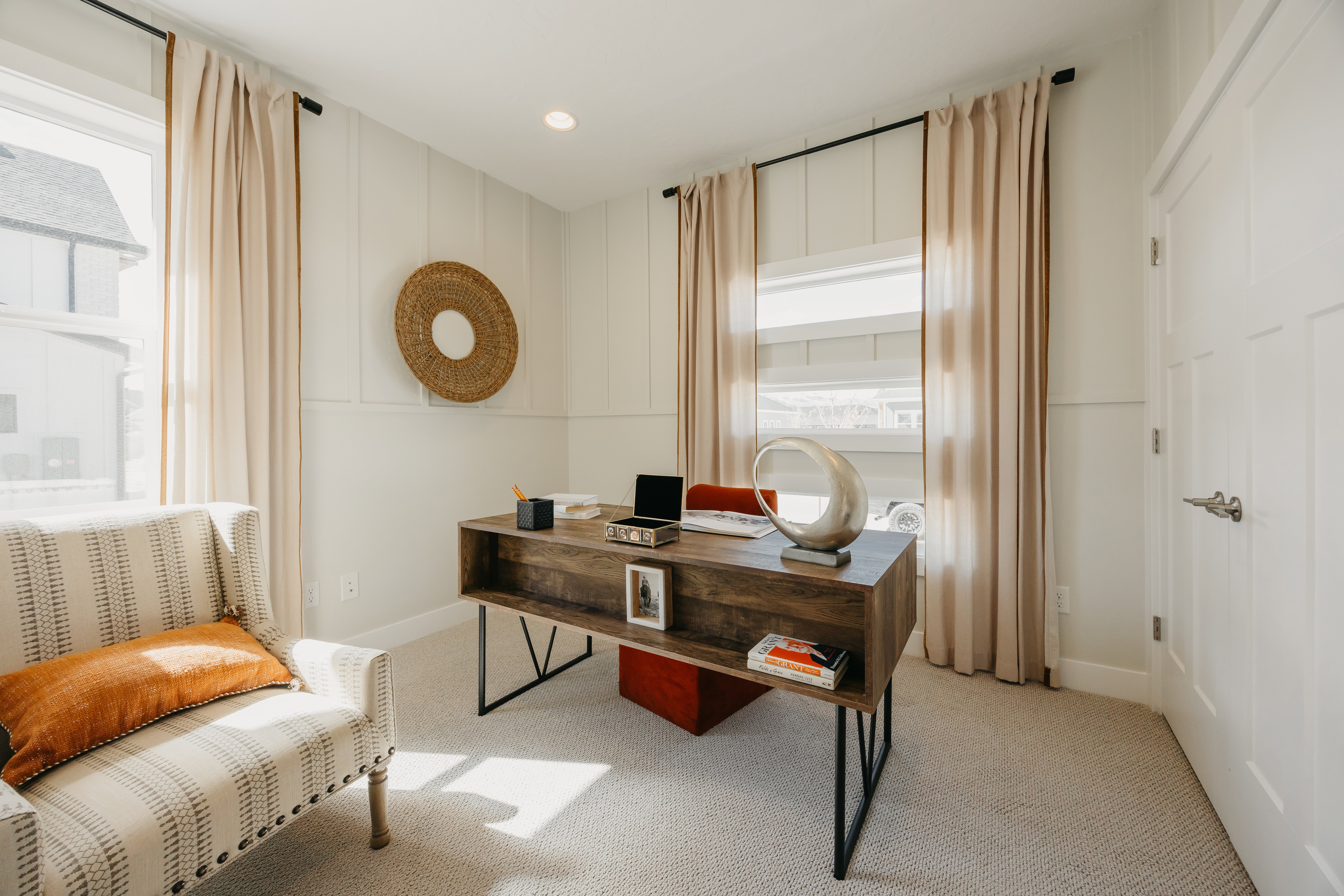 Bright room featuring two windows with natural light, board and batten wall detailing, recessed lighting, and soft carpet flooring