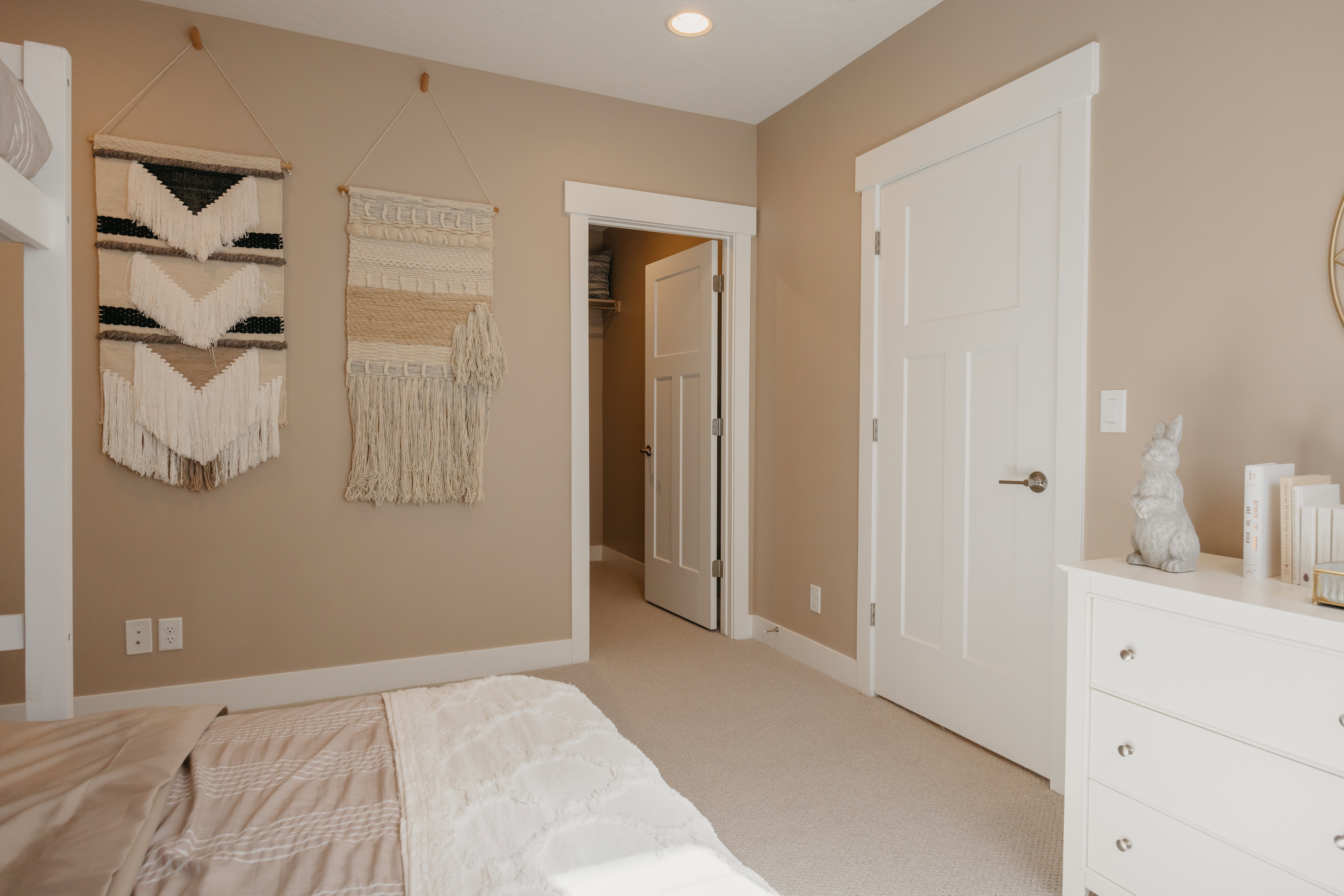 Neutral-toned room featuring a soft carpeted floor and recessed ceiling lighting