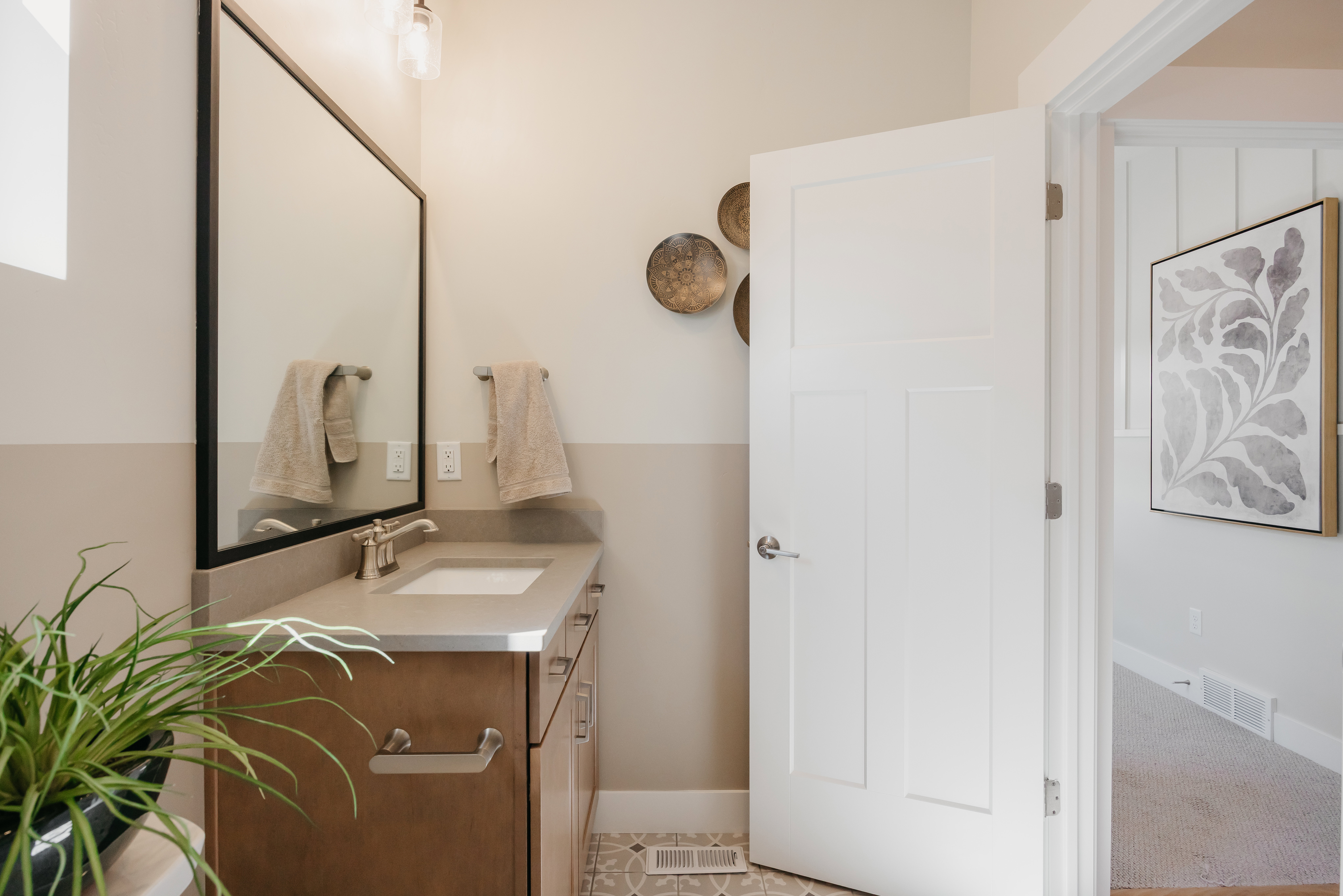 Modern single vanity with a solid surface countertop and undermount sink