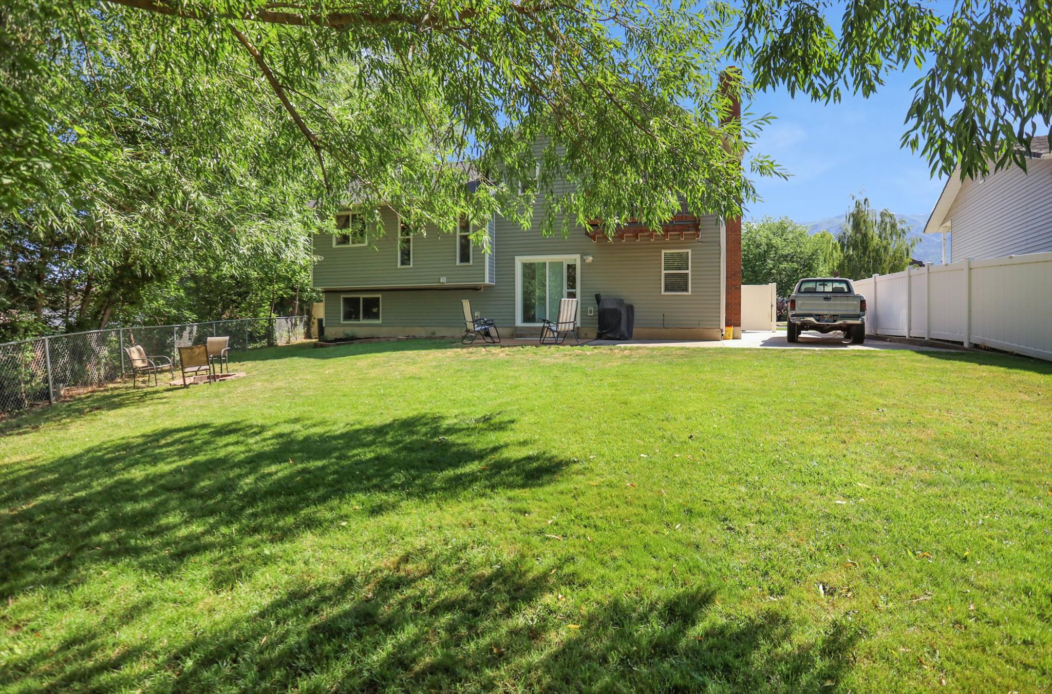 Spacious backyard with a large grass lawn