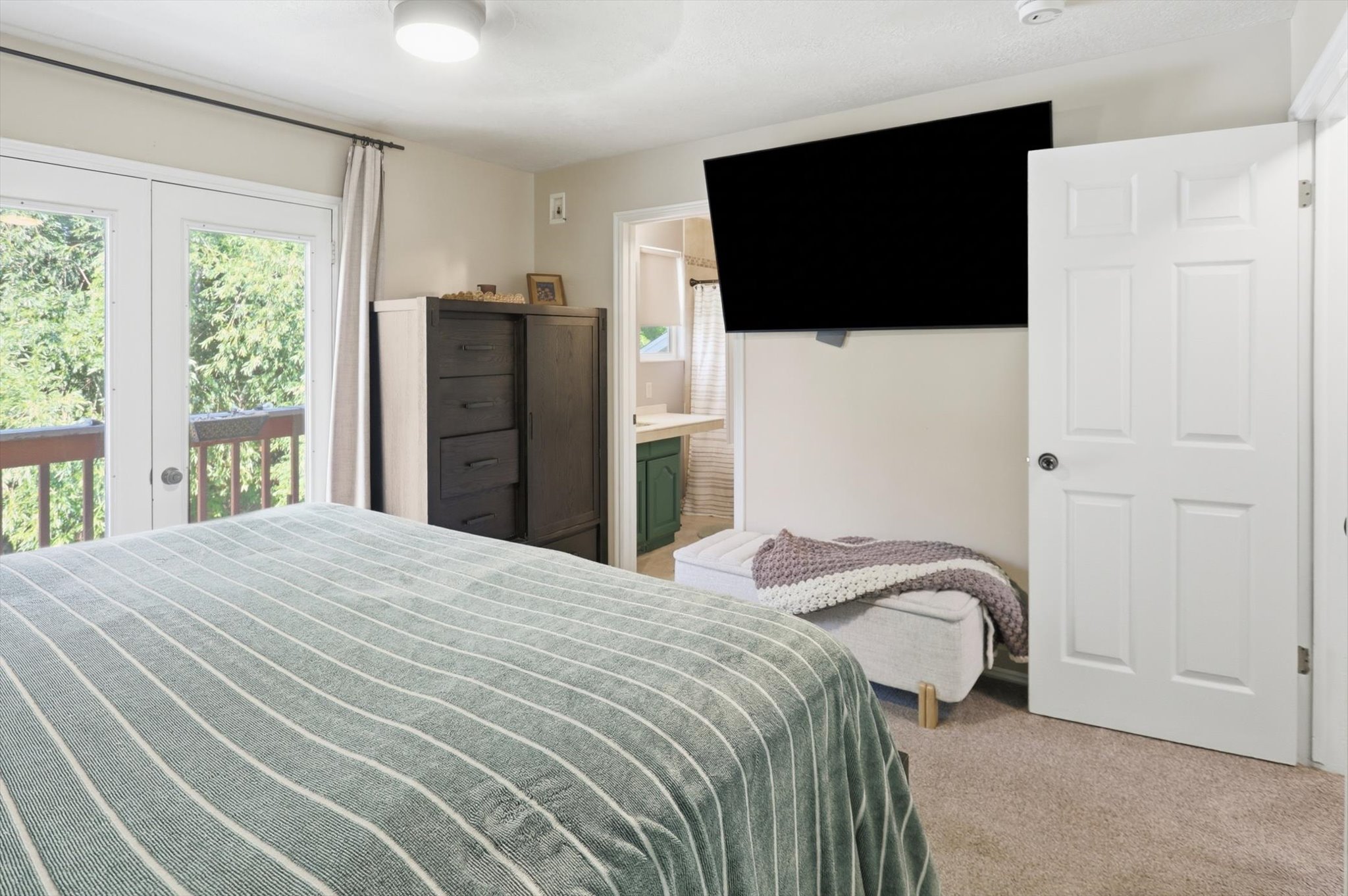 Bedroom featuring light-colored wall-to-wall carpeting and neutral wall paint