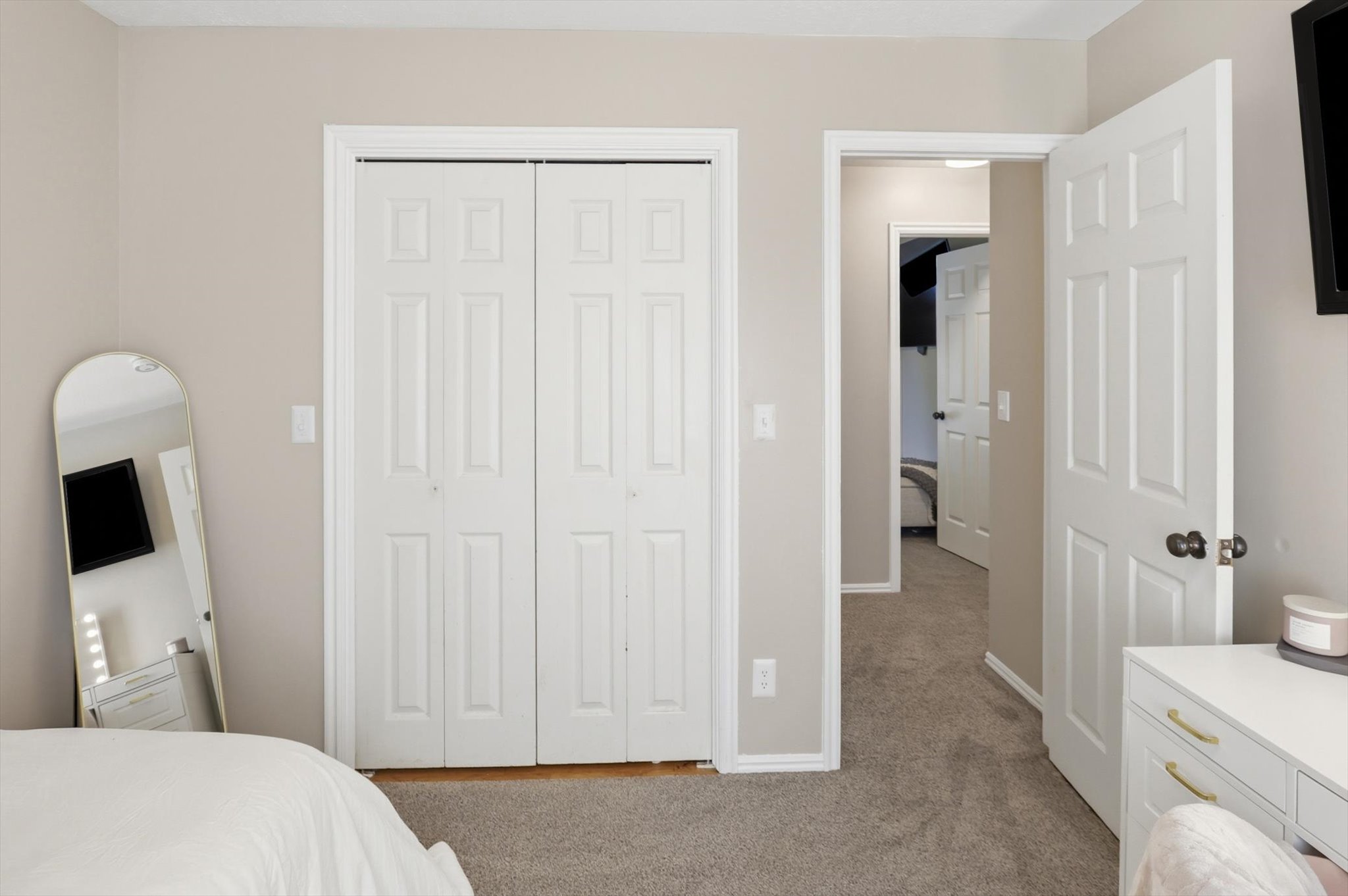 Neutral-toned interior featuring light gray wall paint and gray carpet flooring