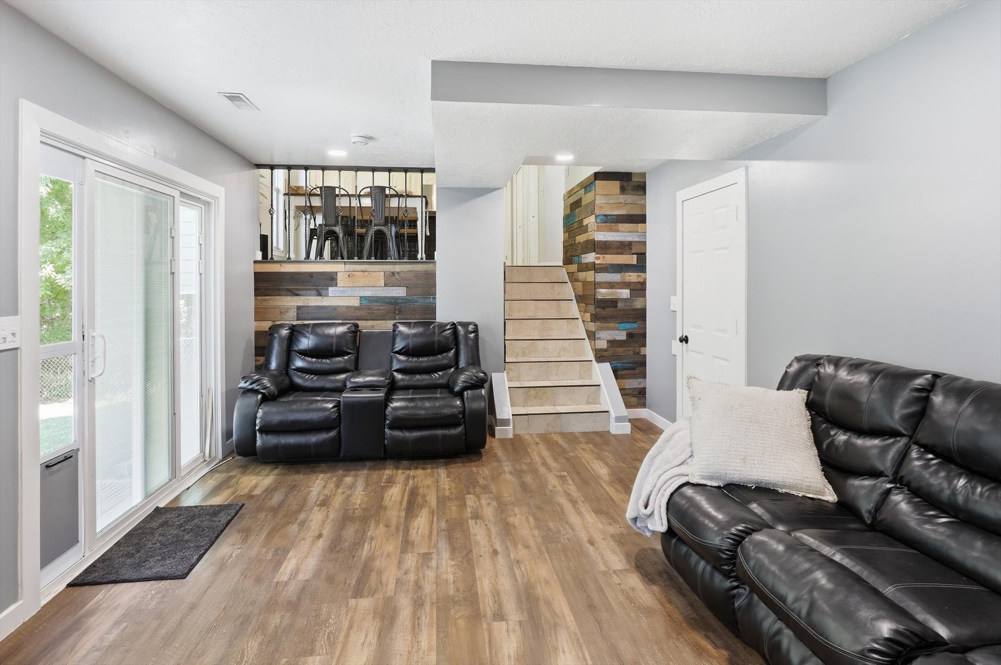 Spacious room featuring wood-finish flooring and light gray walls