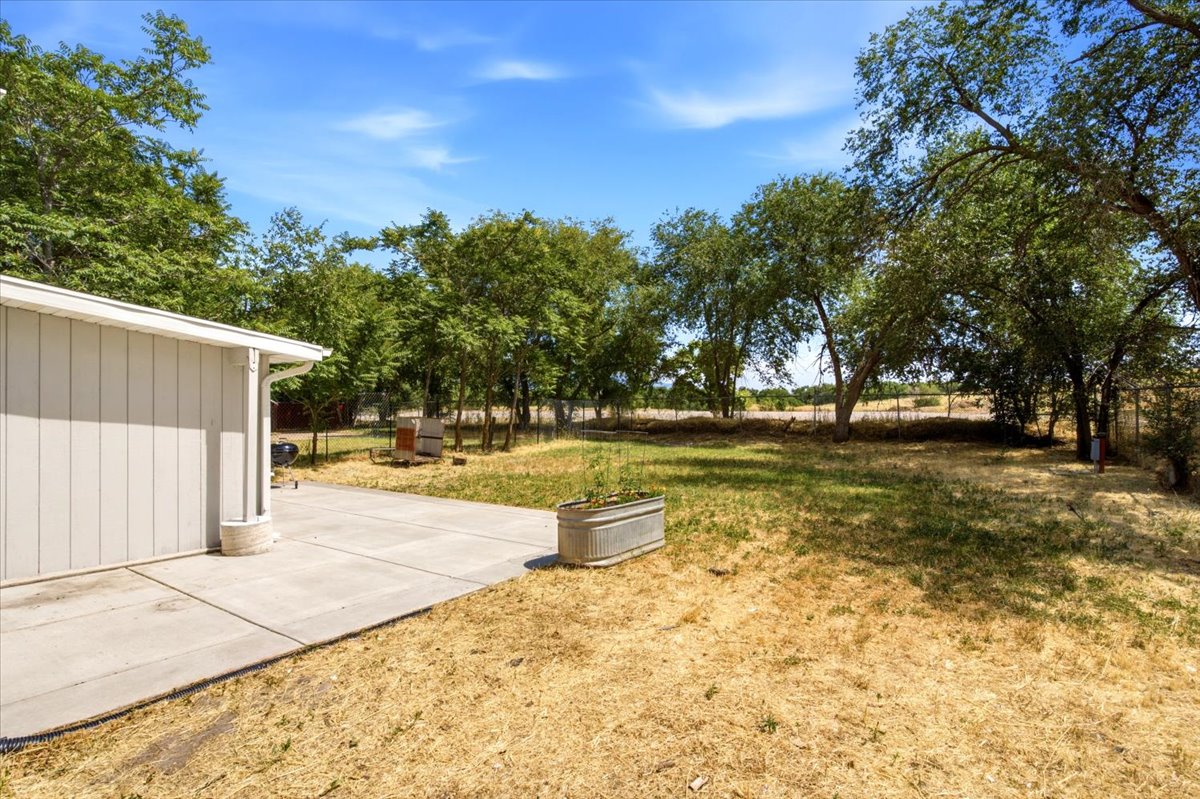 Expansive outdoor space featuring a concrete patio