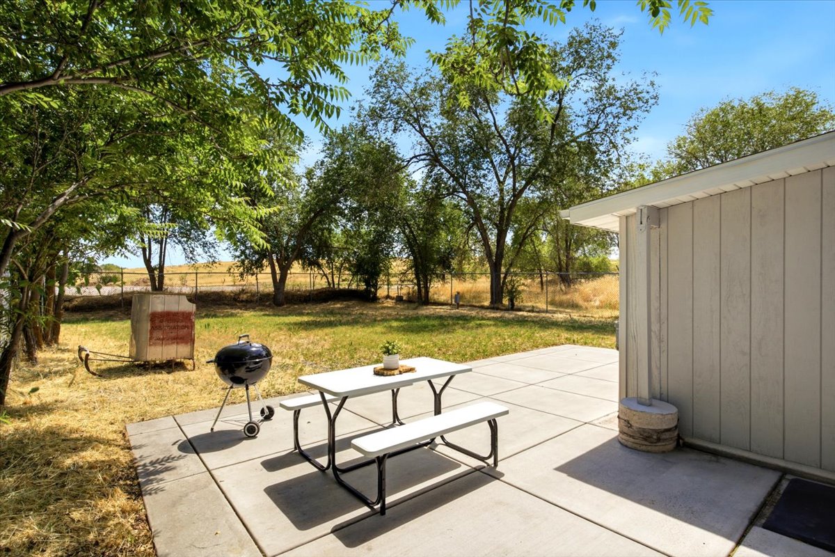 Expansive concrete patio with a freshly painted siding exterior