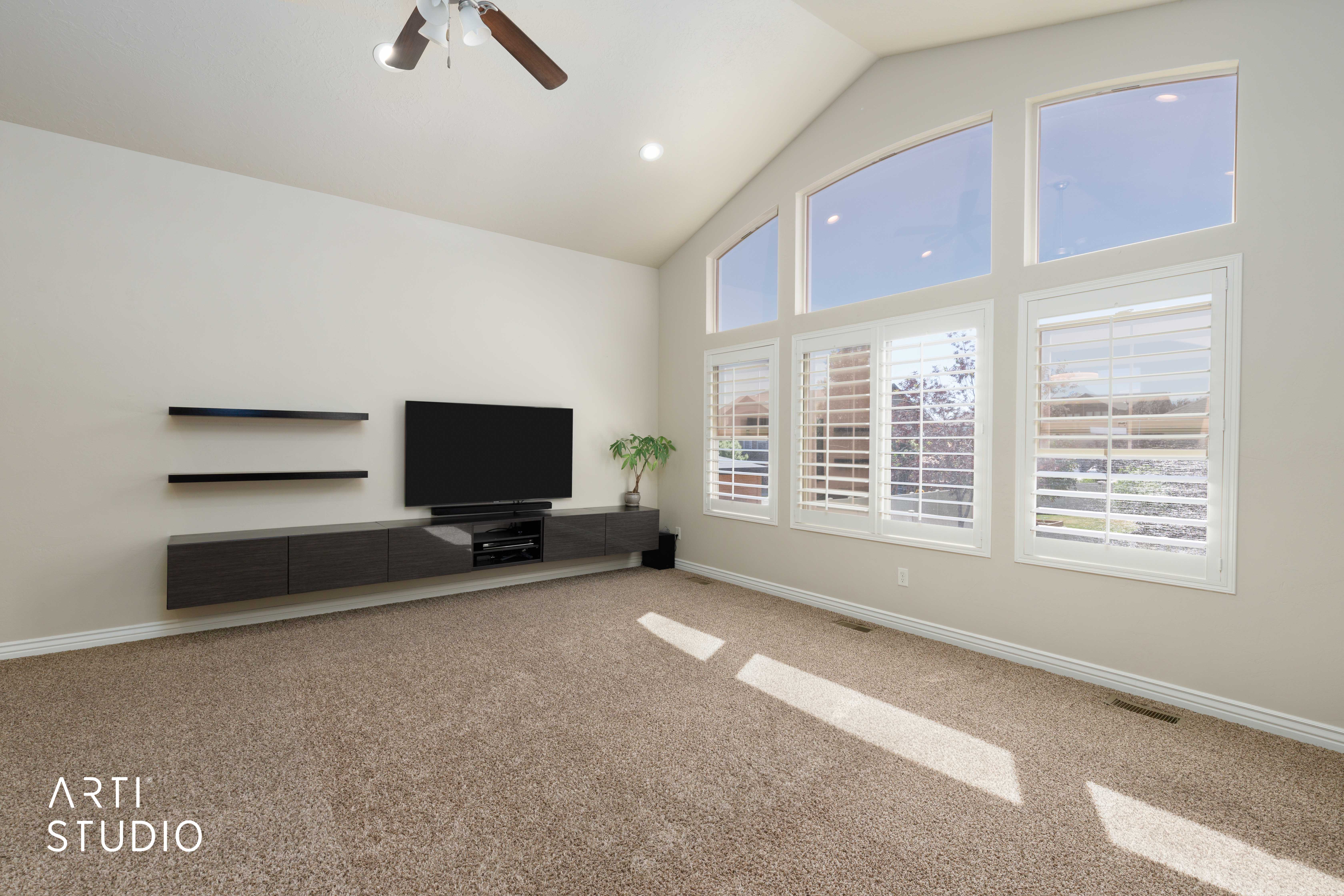 Living area featuring a vaulted ceiling and an array of large windows