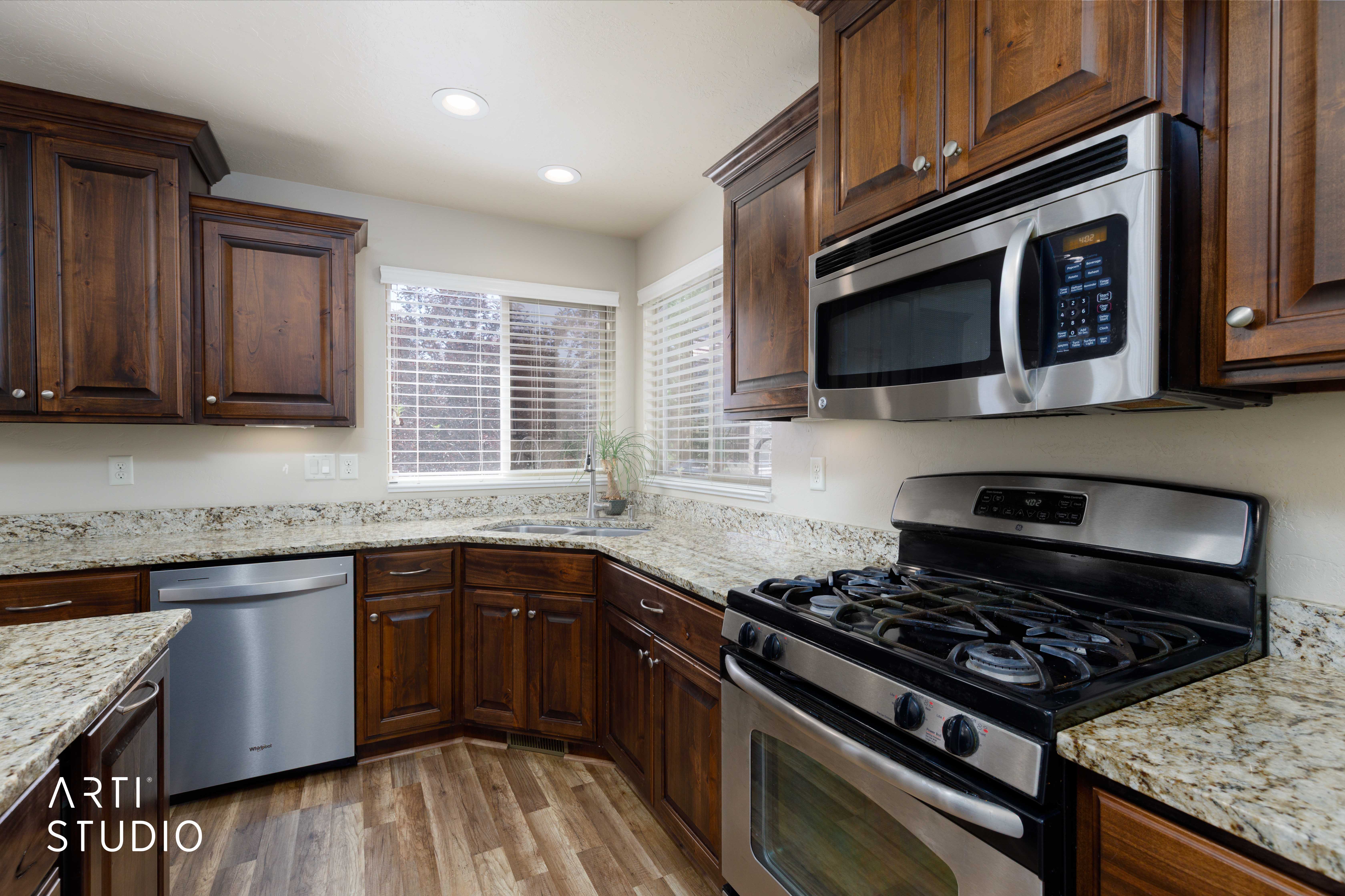 Kitchen featuring stainless steel appliances, wood-finish flooring, recessed lighting, and ample cabinetry