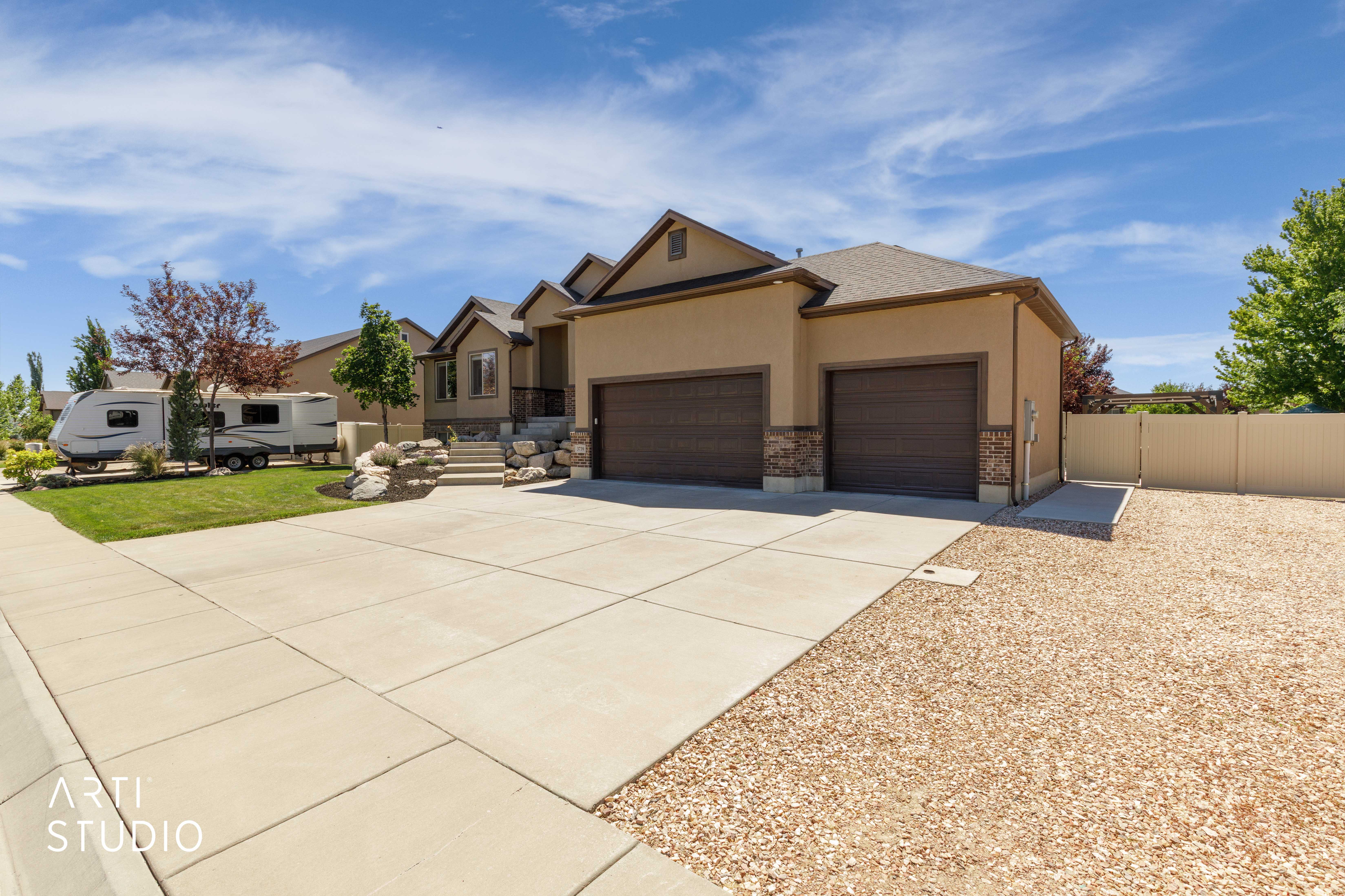 Stucco exterior with stone accents and a two-car garage