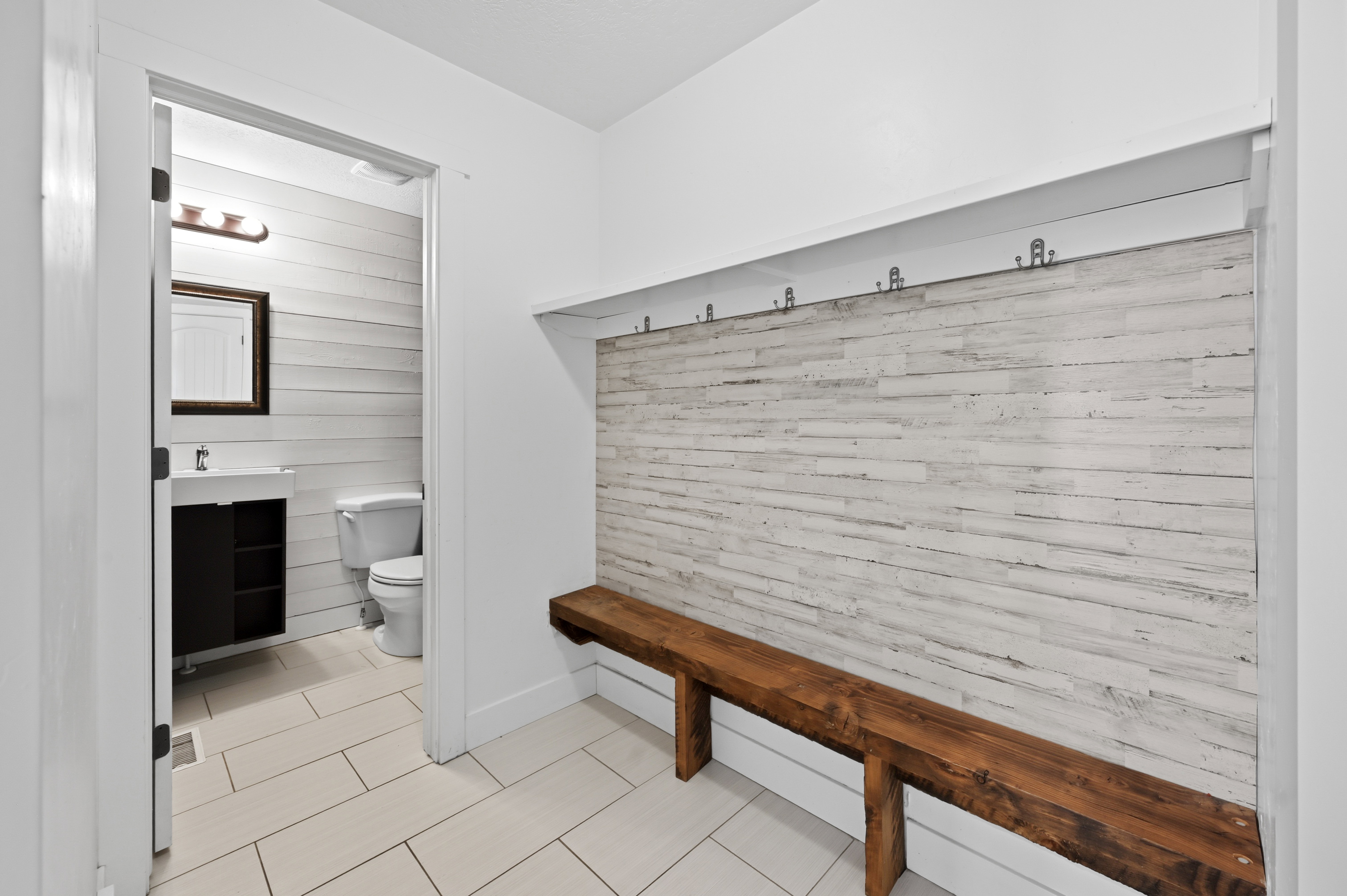 Built-in hall tree featuring a rustic wood-finish bench and paneling