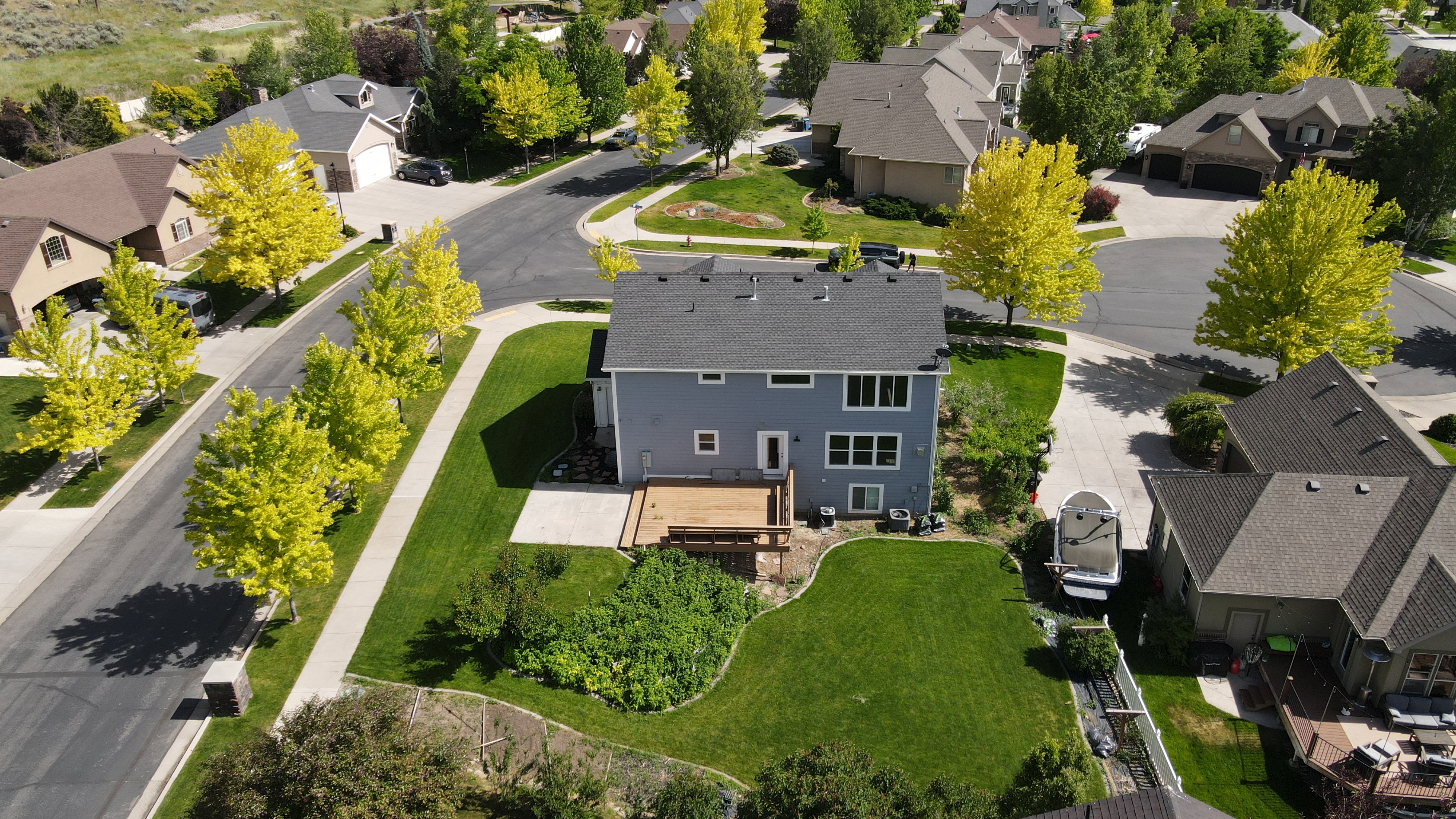 Two-story residence featuring a gray exterior and a shingle roof