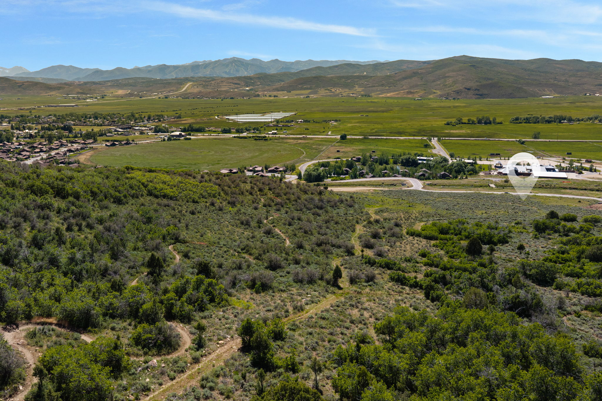 Expansive natural landscape featuring rolling hills and distant mountains