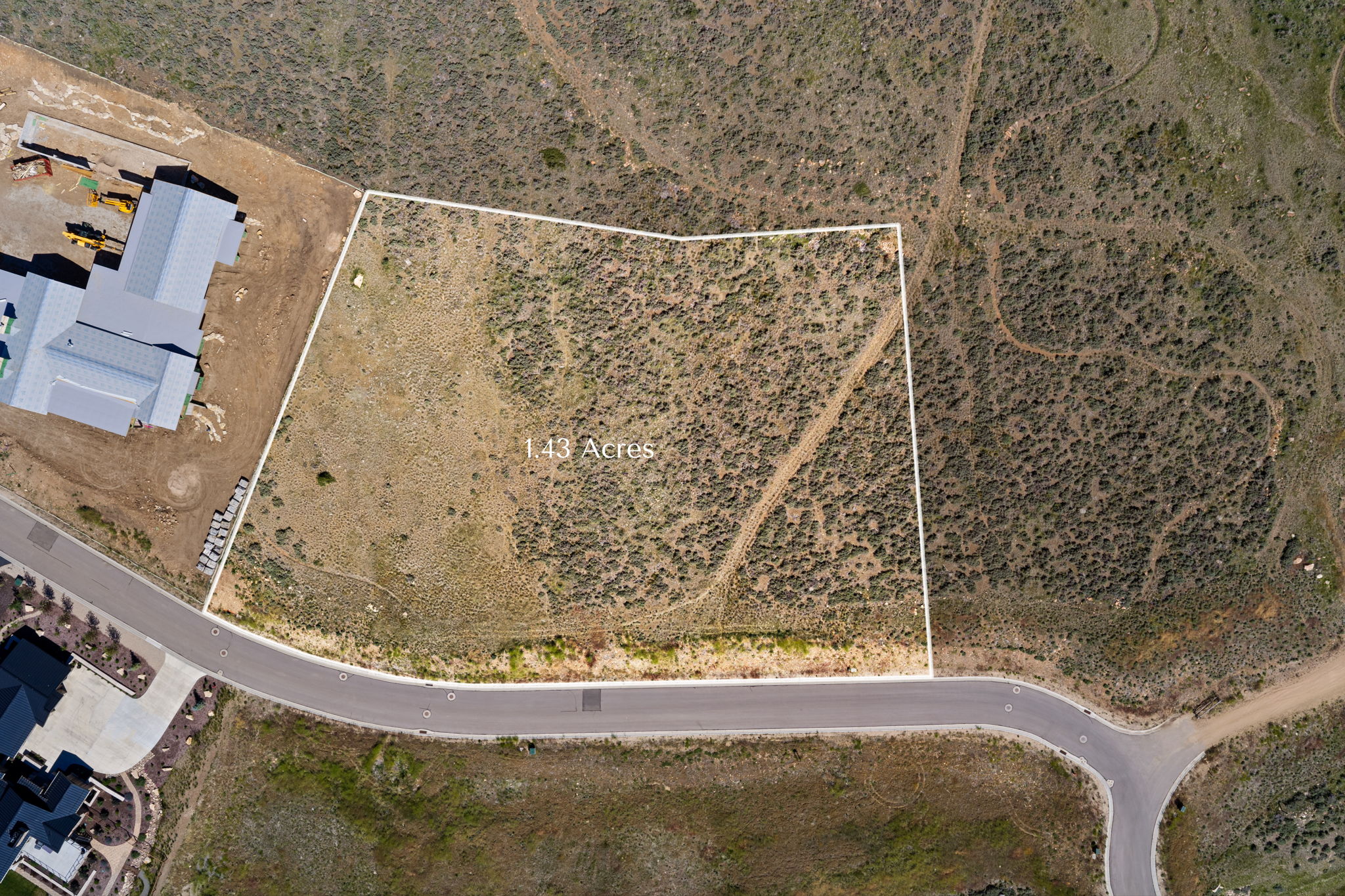 Expansive 1.43-acre lot featuring natural, undeveloped terrain