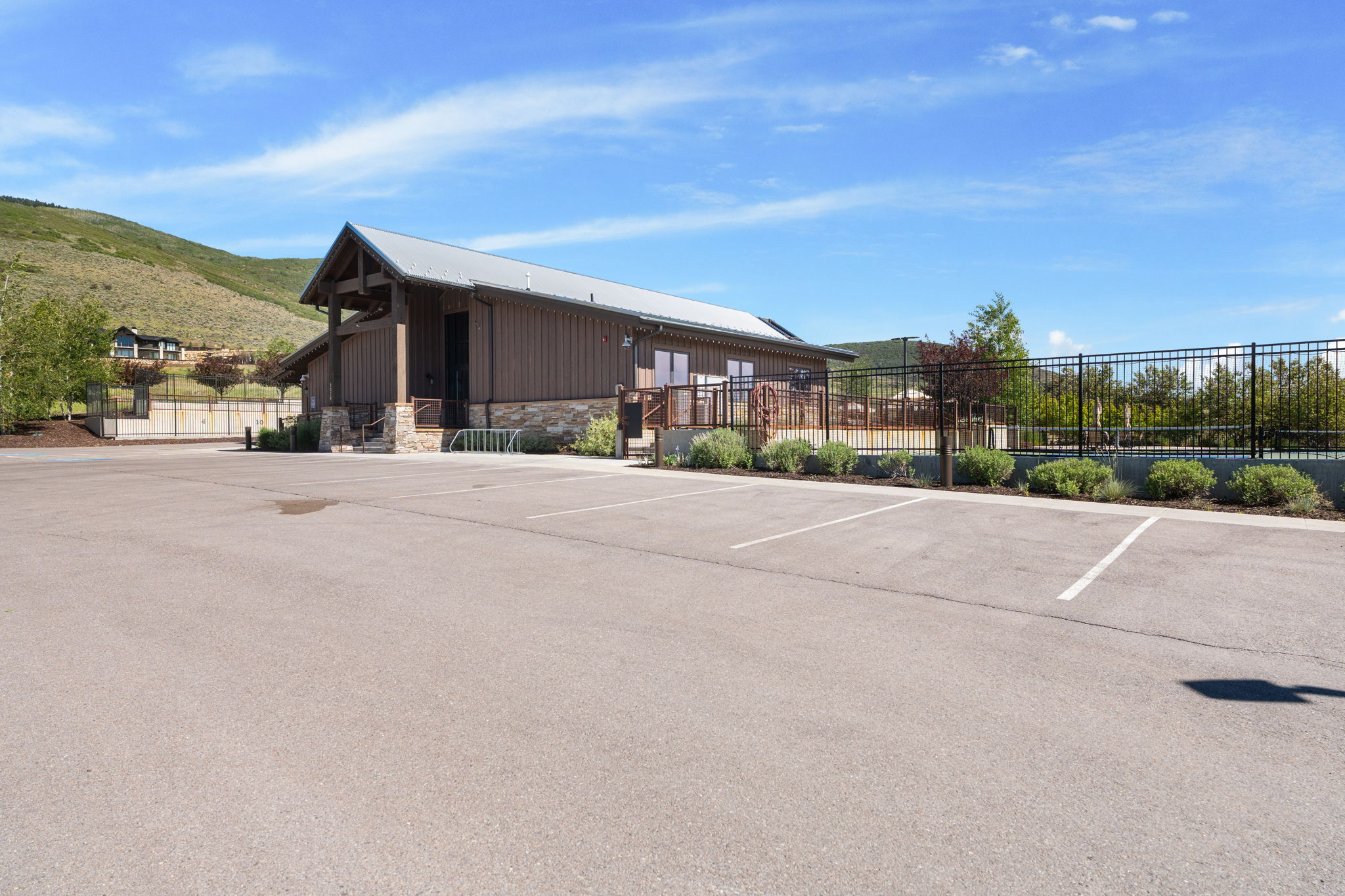 Barn-style building featuring a metal roof, wood siding, and a stone facade