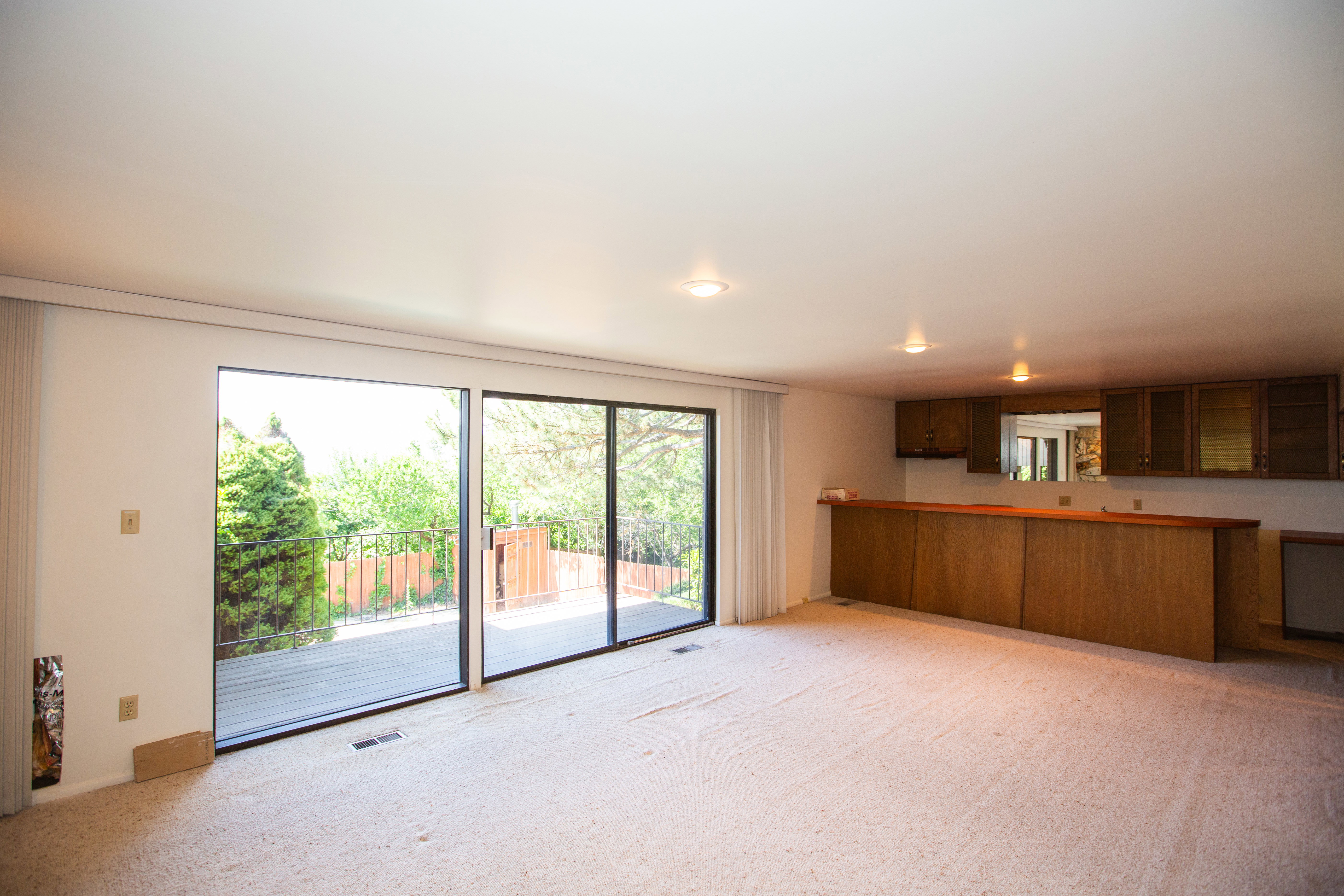 Spacious room with light-toned carpeting and recessed lighting