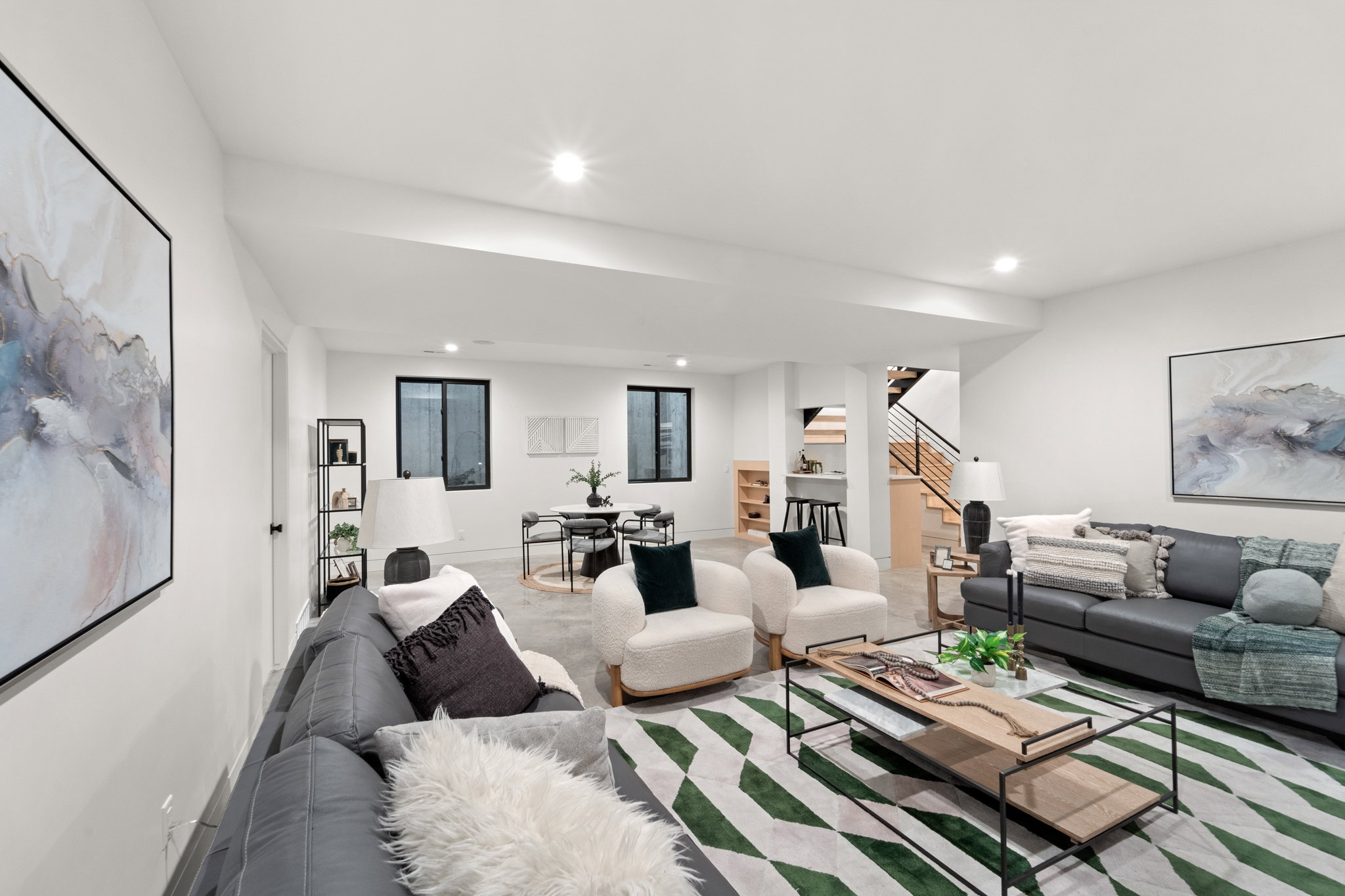 Bright, spacious living area featuring recessed lighting and light-toned walls