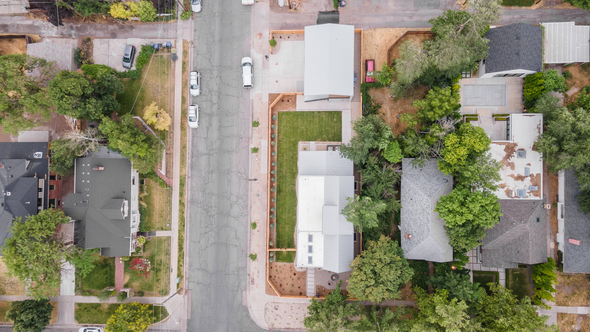 Aerial perspective showcasing two modern residences with metal roofs and private outdoor spaces