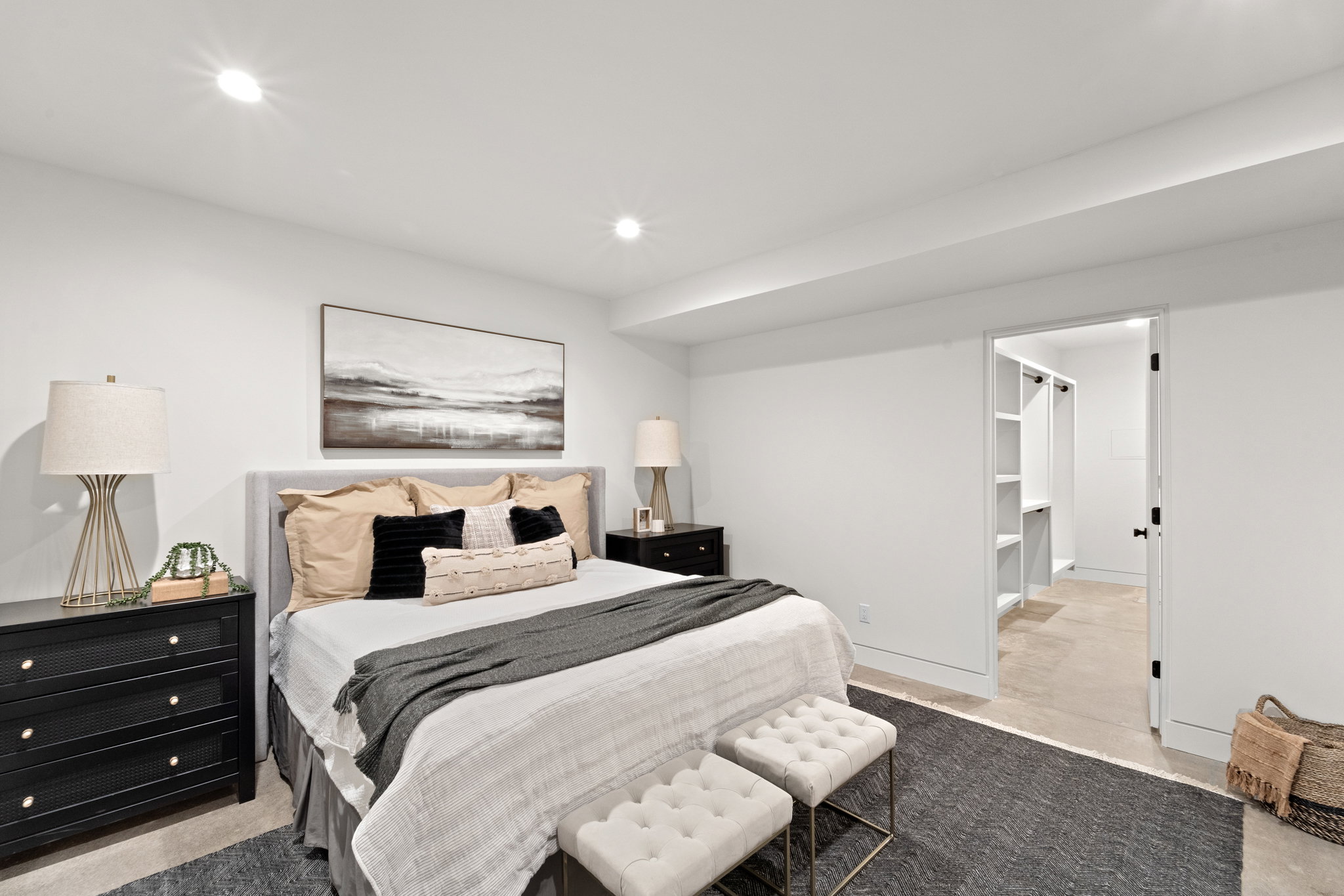 White bedroom featuring recessed lighting, a built-in closet with shelving, and light-colored flooring extending into the closet