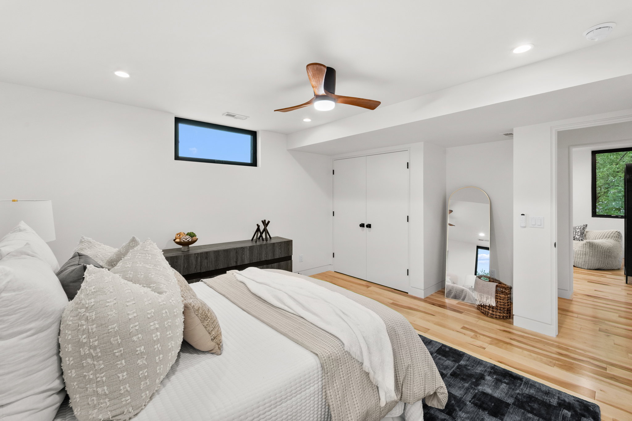 Bedroom featuring light wood-finish flooring, recessed lighting, and a dark wood ceiling fan
