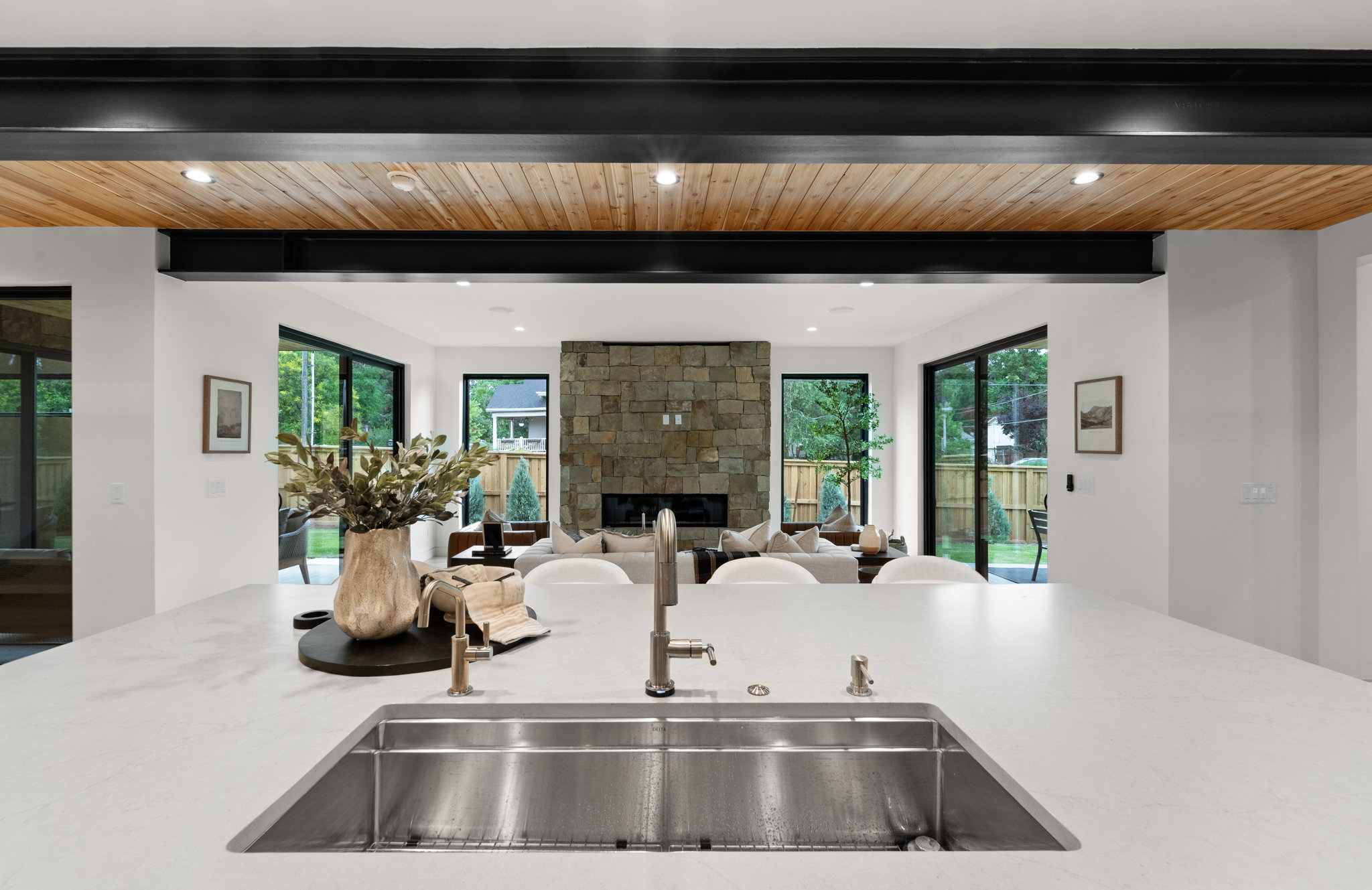 Kitchen island featuring an undermount stainless steel sink and a contemporary faucet