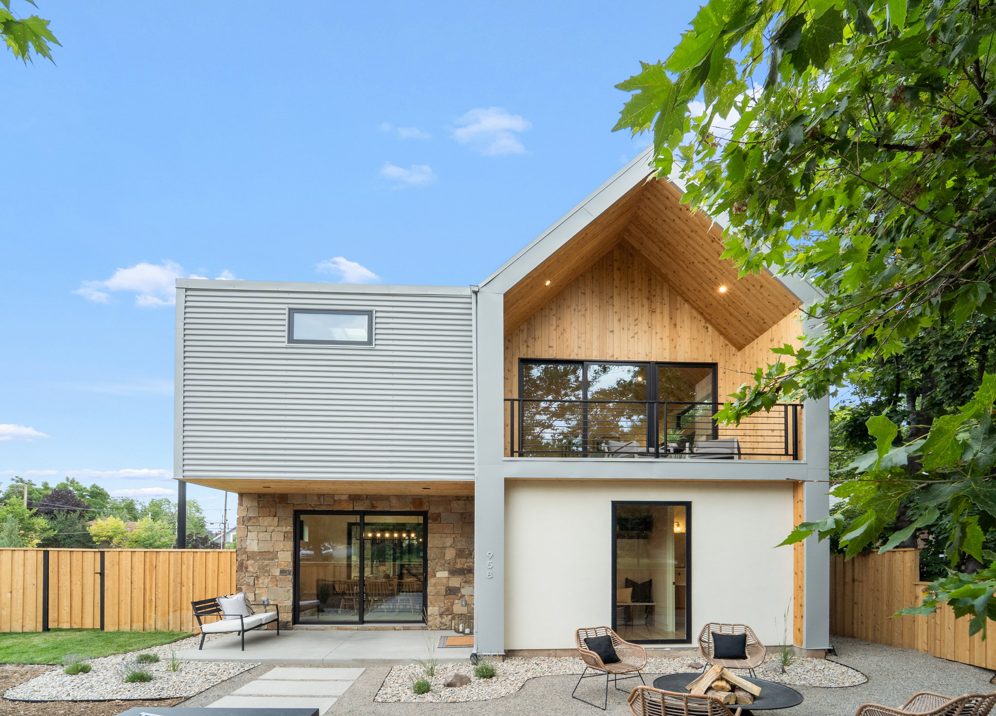 Contemporary exterior with horizontal corrugated siding and natural stone accents
