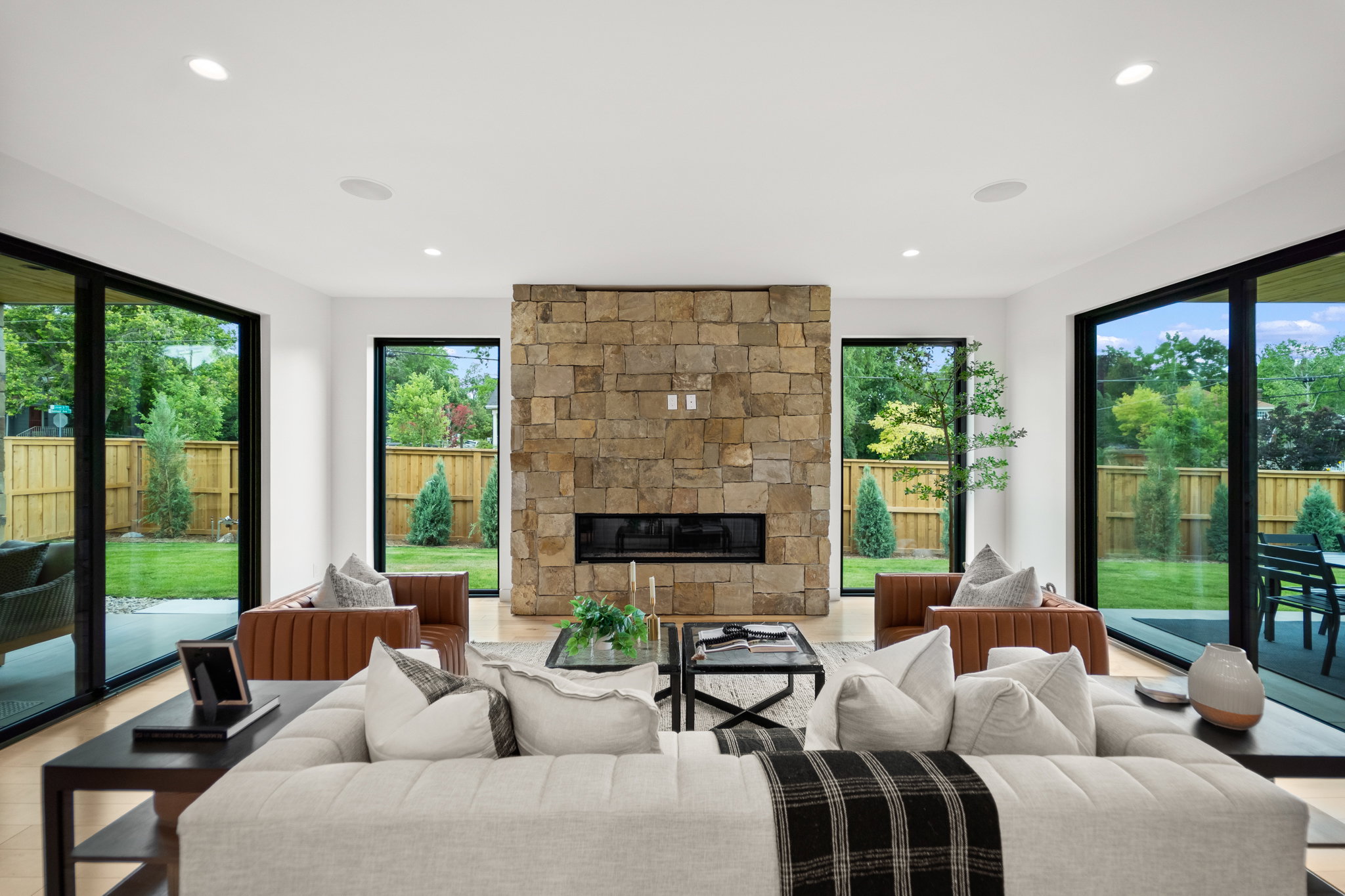 Spacious interior with stone-clad fireplace and linear fire feature