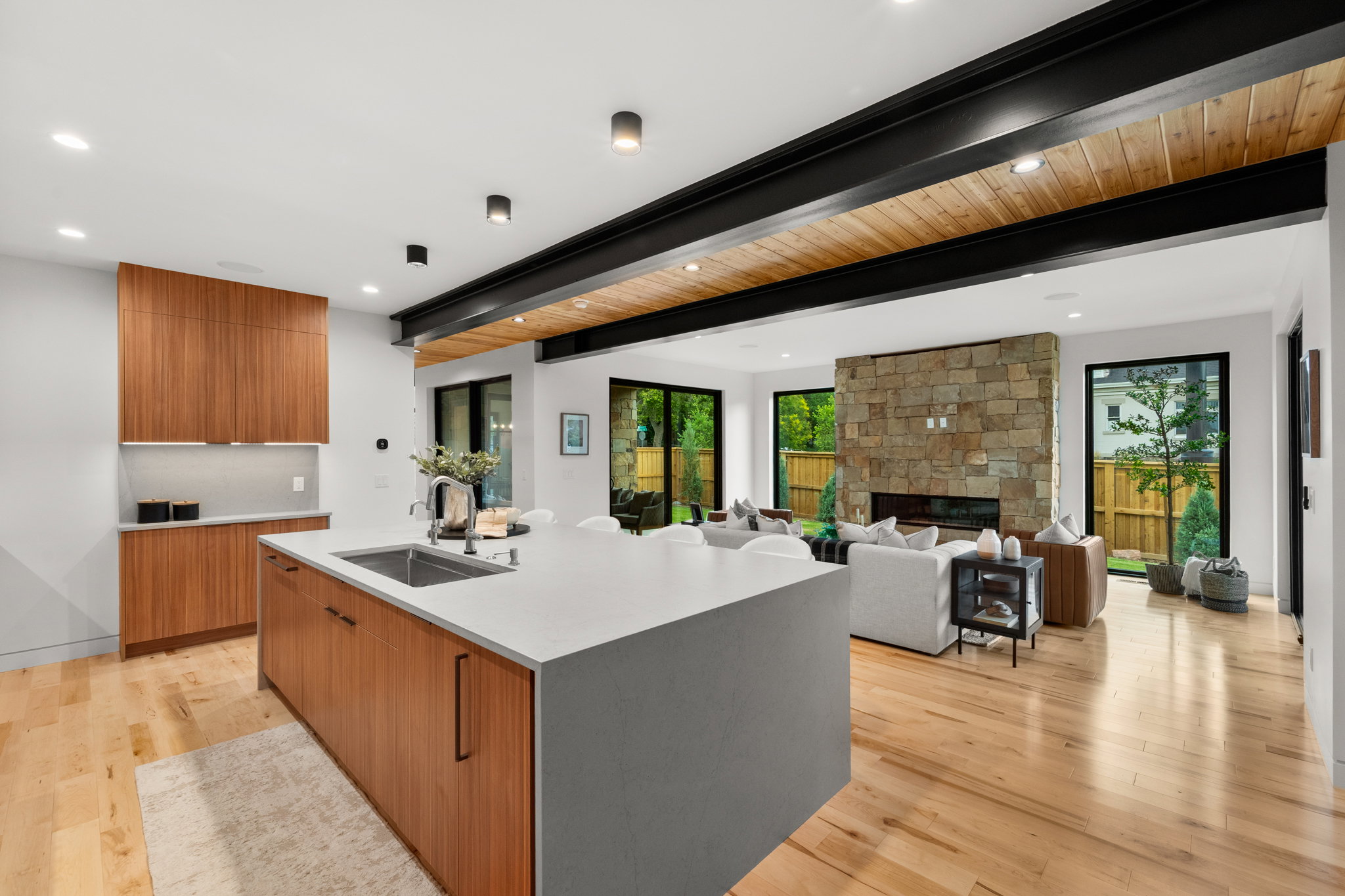 Kitchen island with an undermount sink and light-toned countertop